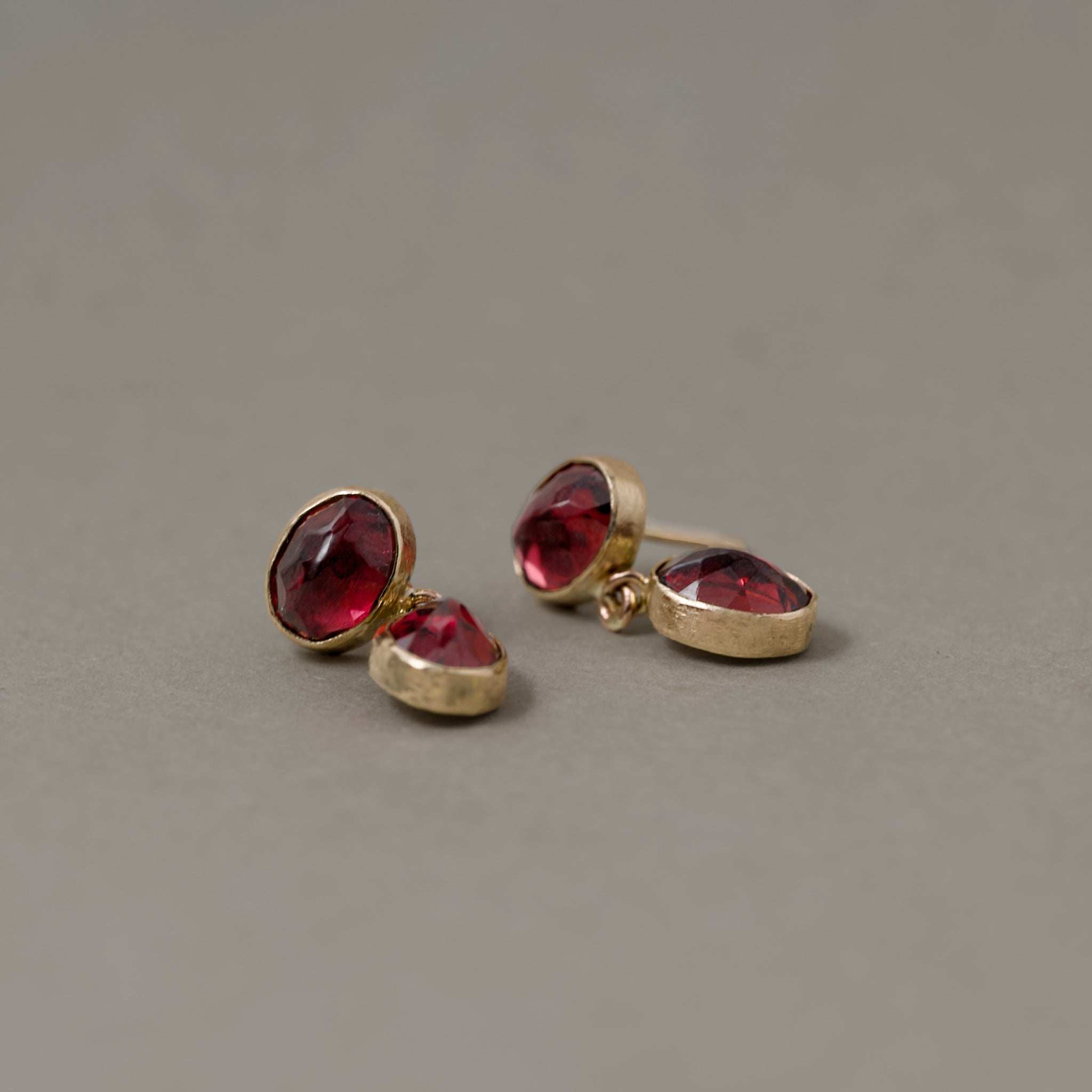 Duo Rhodolite Garnet stud earrings with vibrant Duo Paraíba Tourmaline stones in gold setting