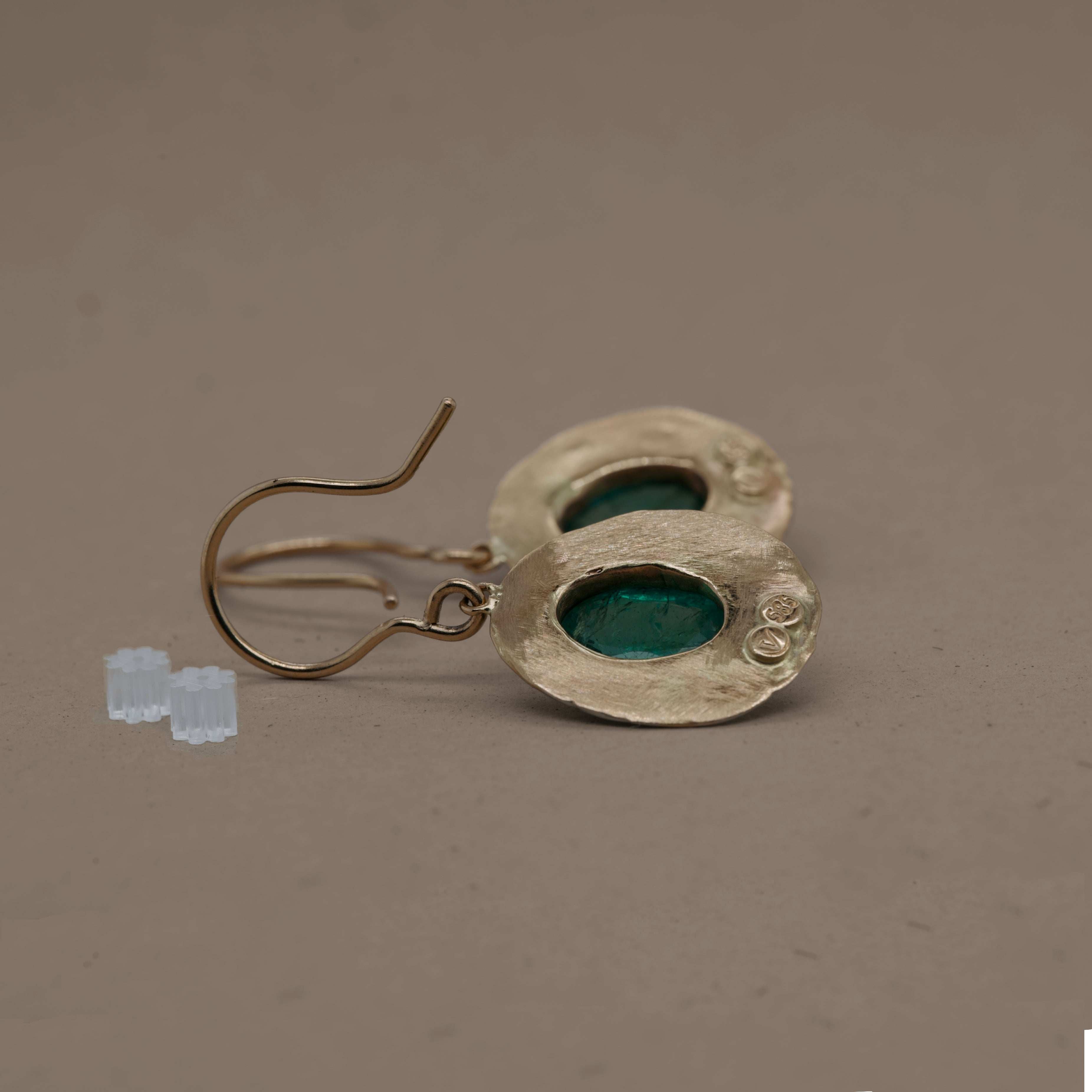 Opulent Florin Emerald Earrings in hammered gold with blue-green emeralds.