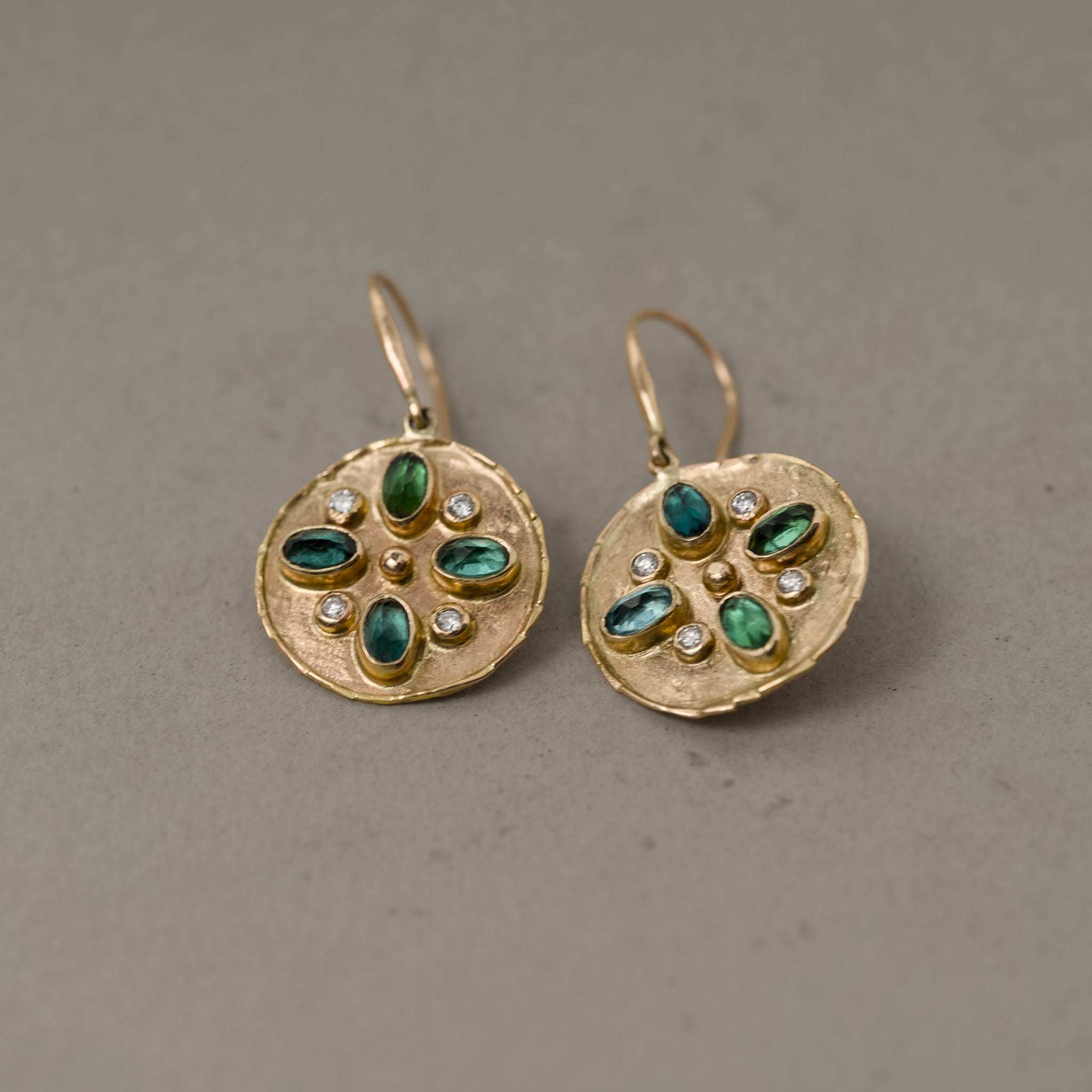 Handcrafted gold earrings set with indicolite tourmaline and sparkling diamonds