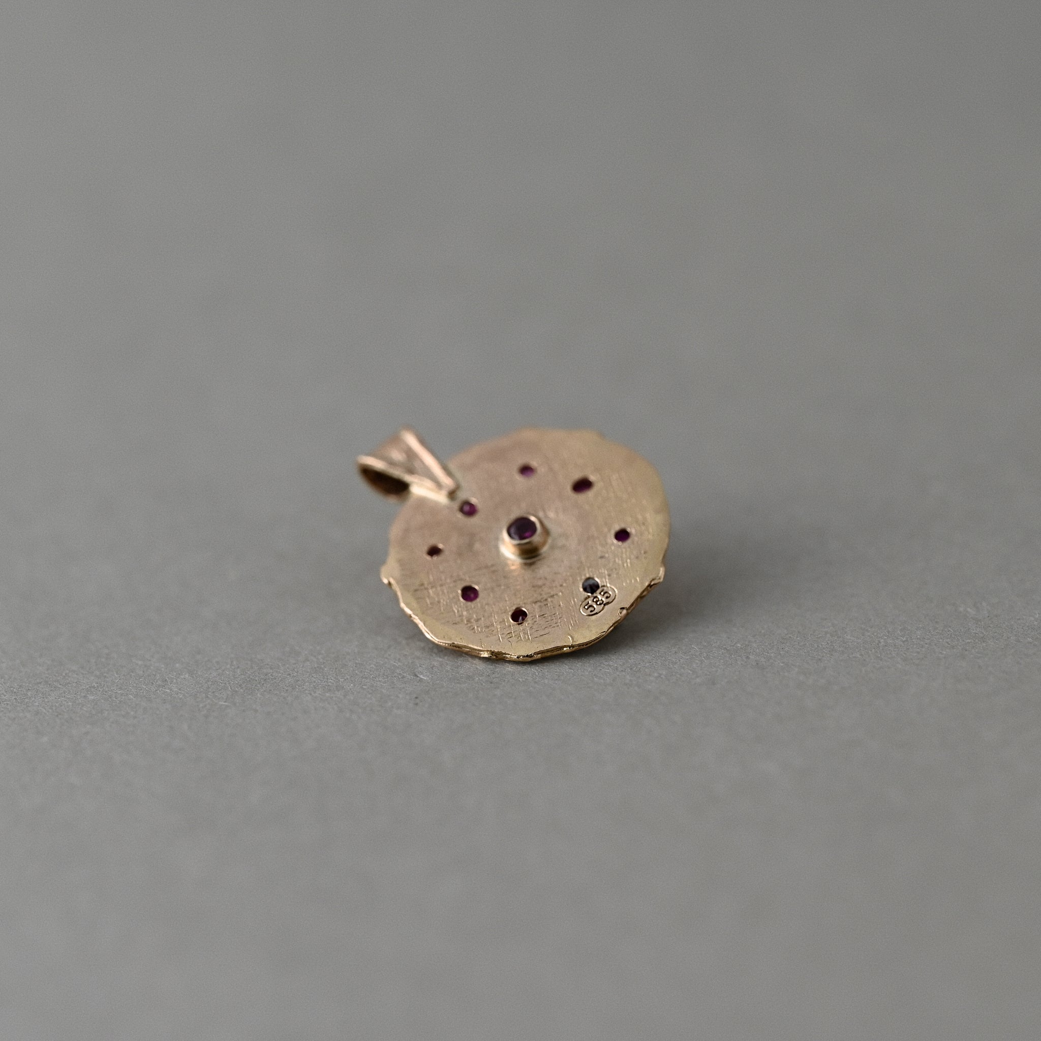 Back of Florin Mozambique ruby medallion showing signature ruby and 14ct solid gold