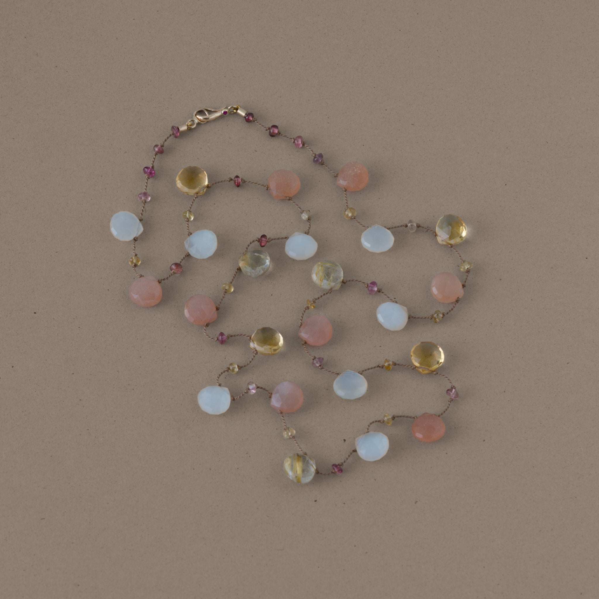 Moonstone and citrine gemstone necklace with gold clasp and ruby accents.