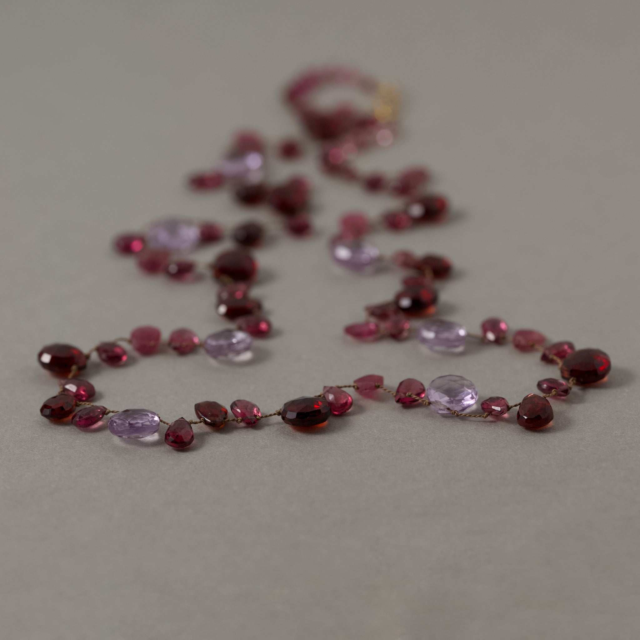 Lido Garnet Tourmaline Amethyst gemstone necklace with gold clasp on silk strand