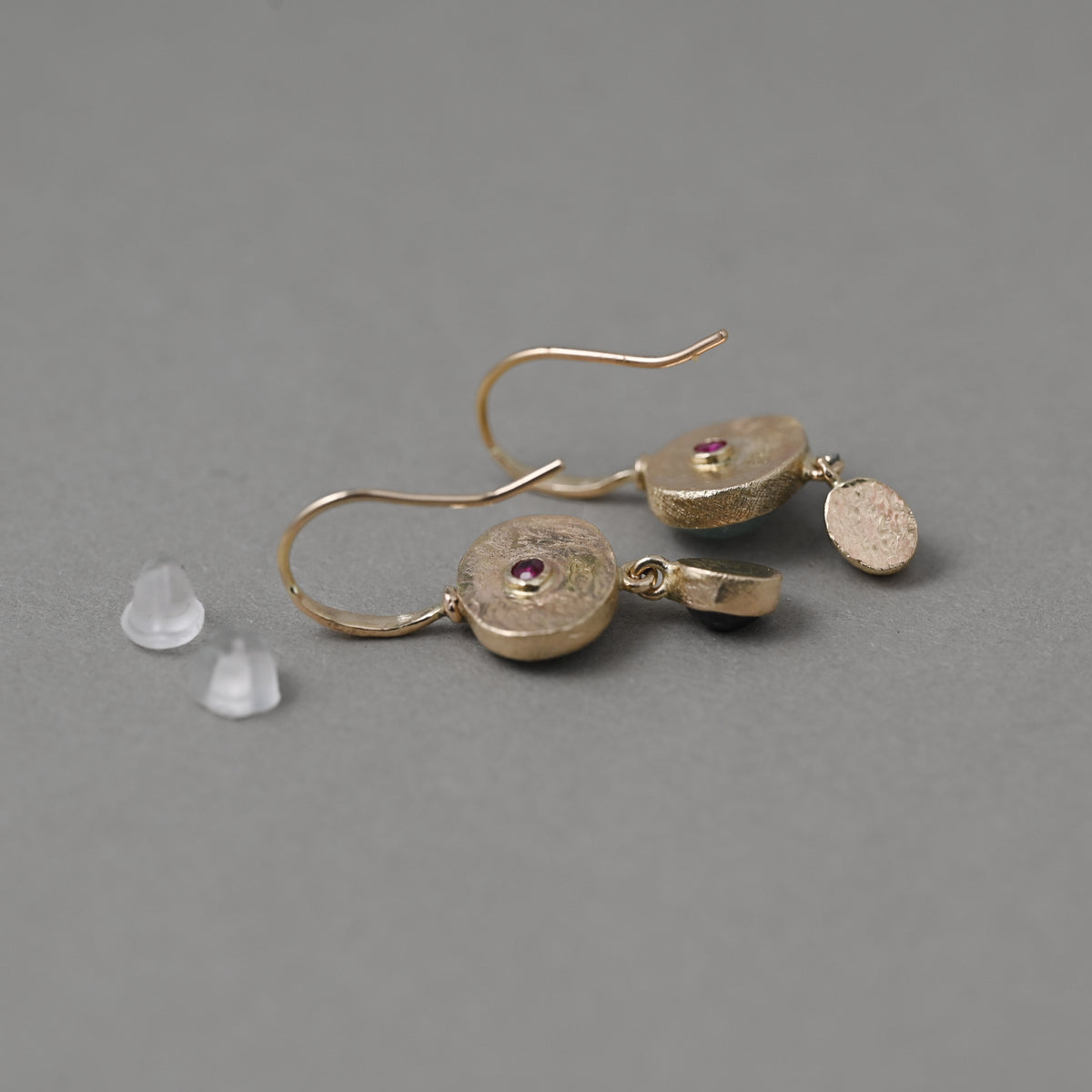 Sera Paraiba Sapphire 14k earrings showing backs with vermilion ruby gemstones