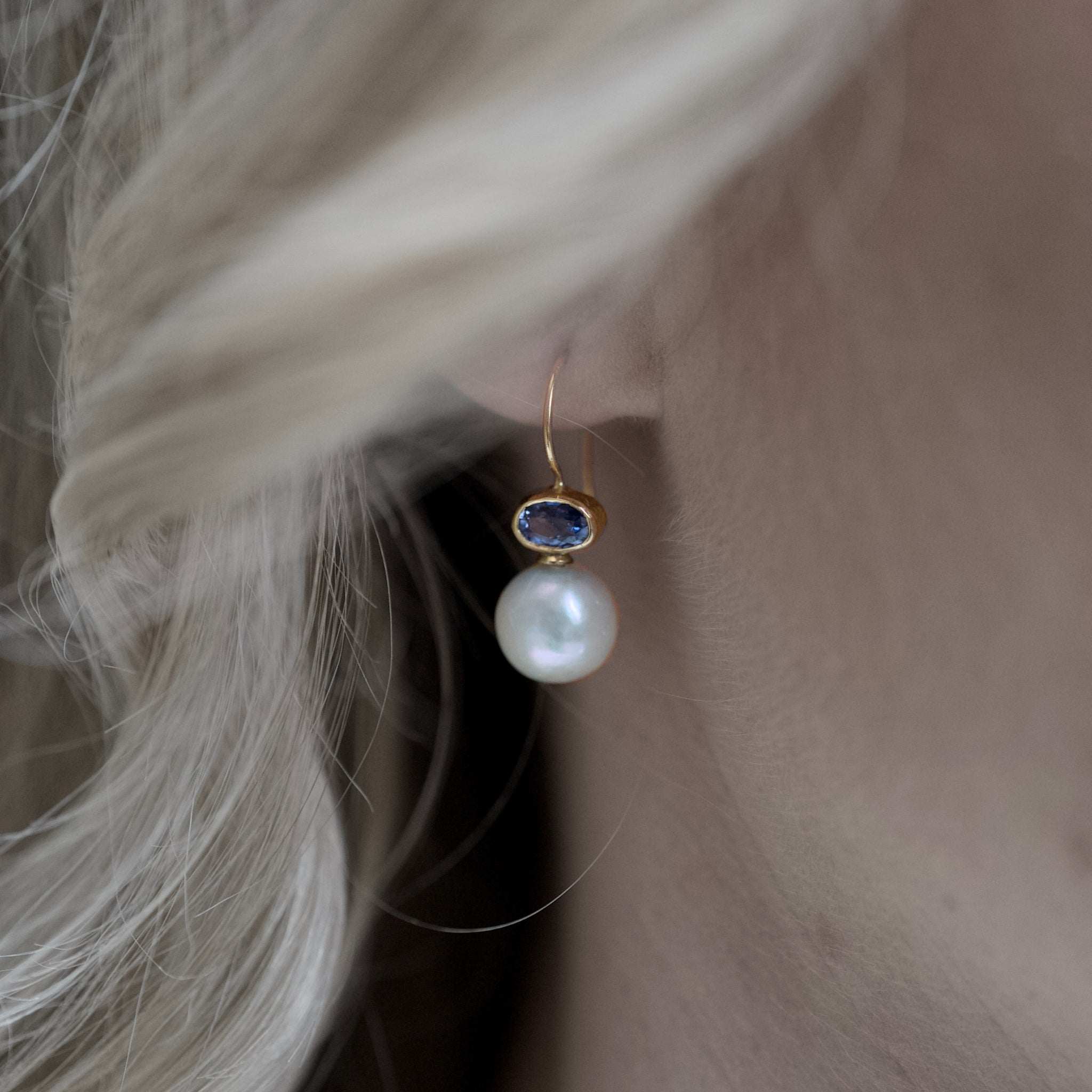 Elegant gold earrings featuring Ceylon sapphire gemstones and luminous white pearls