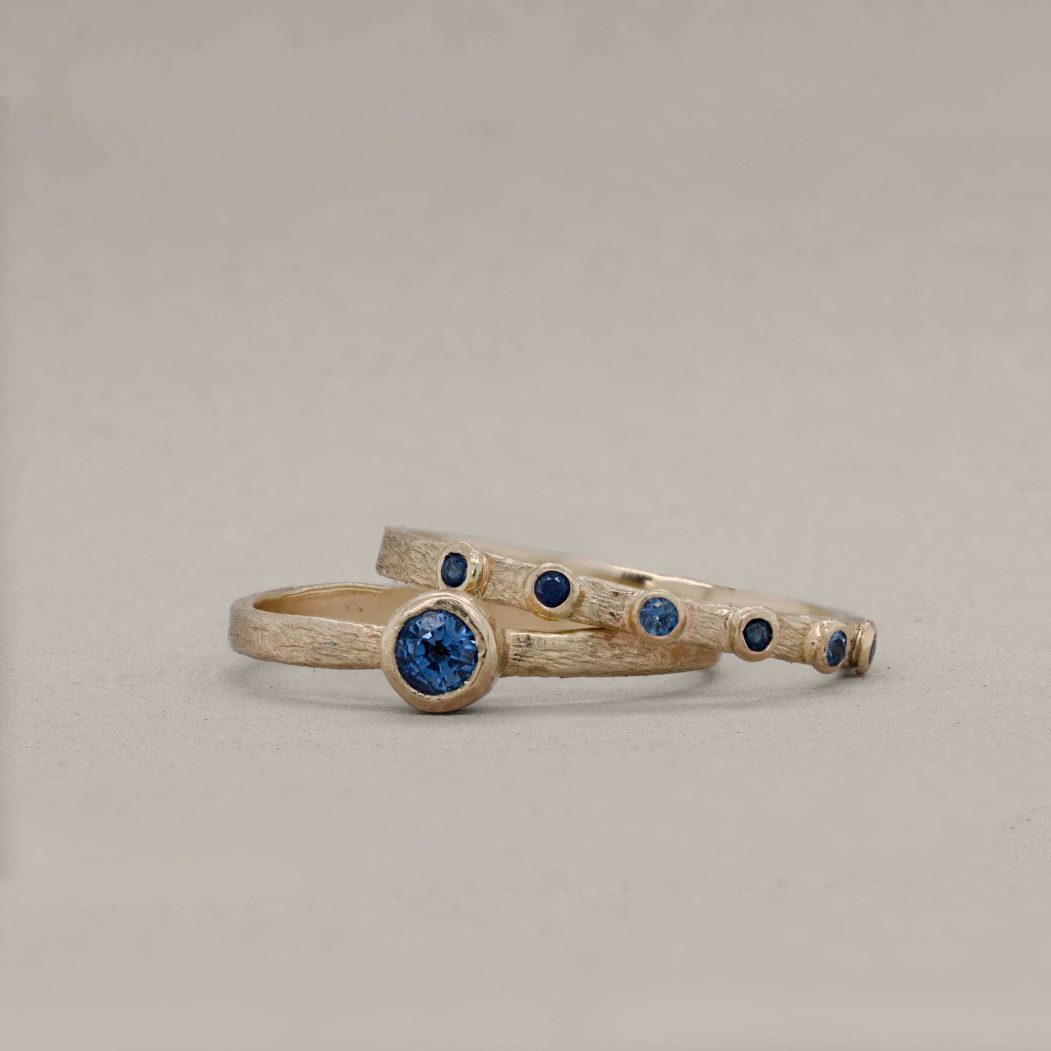 Soletta Sapphire Ring featuring cornflower blue sapphires set in brushed gold bands