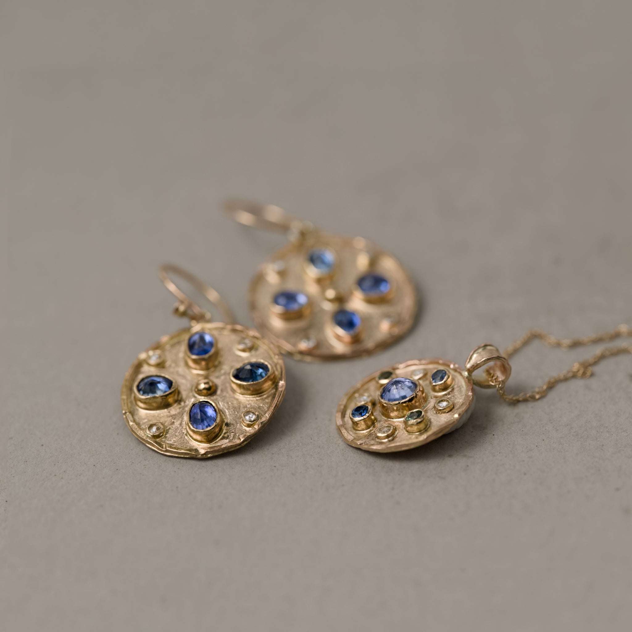 Celestial blue sapphire diamond earrings held in gold with rose-cut diamonds