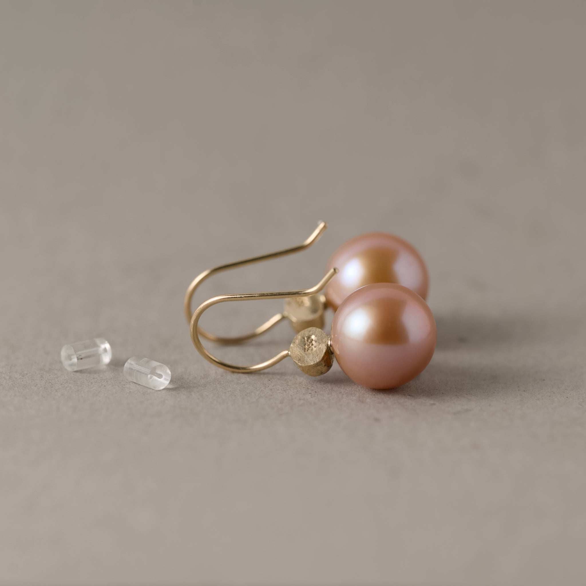backs of latte cream pearl Edison earrings with oval sapphires