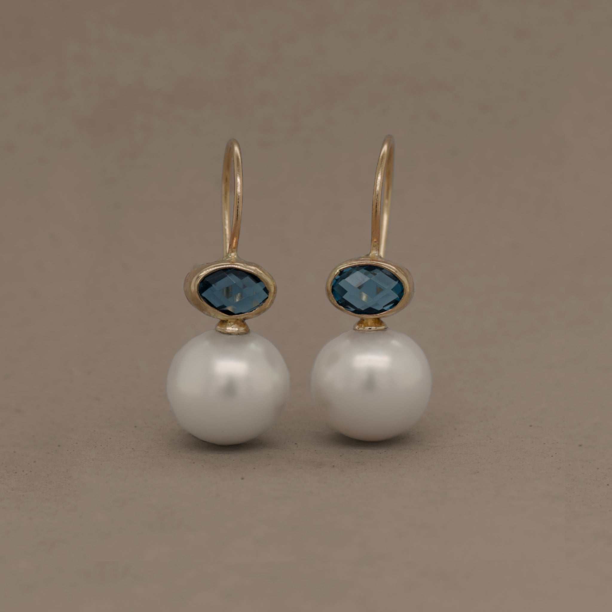 Elegant London Blue Topaz pearl earrings with gold embellishments.