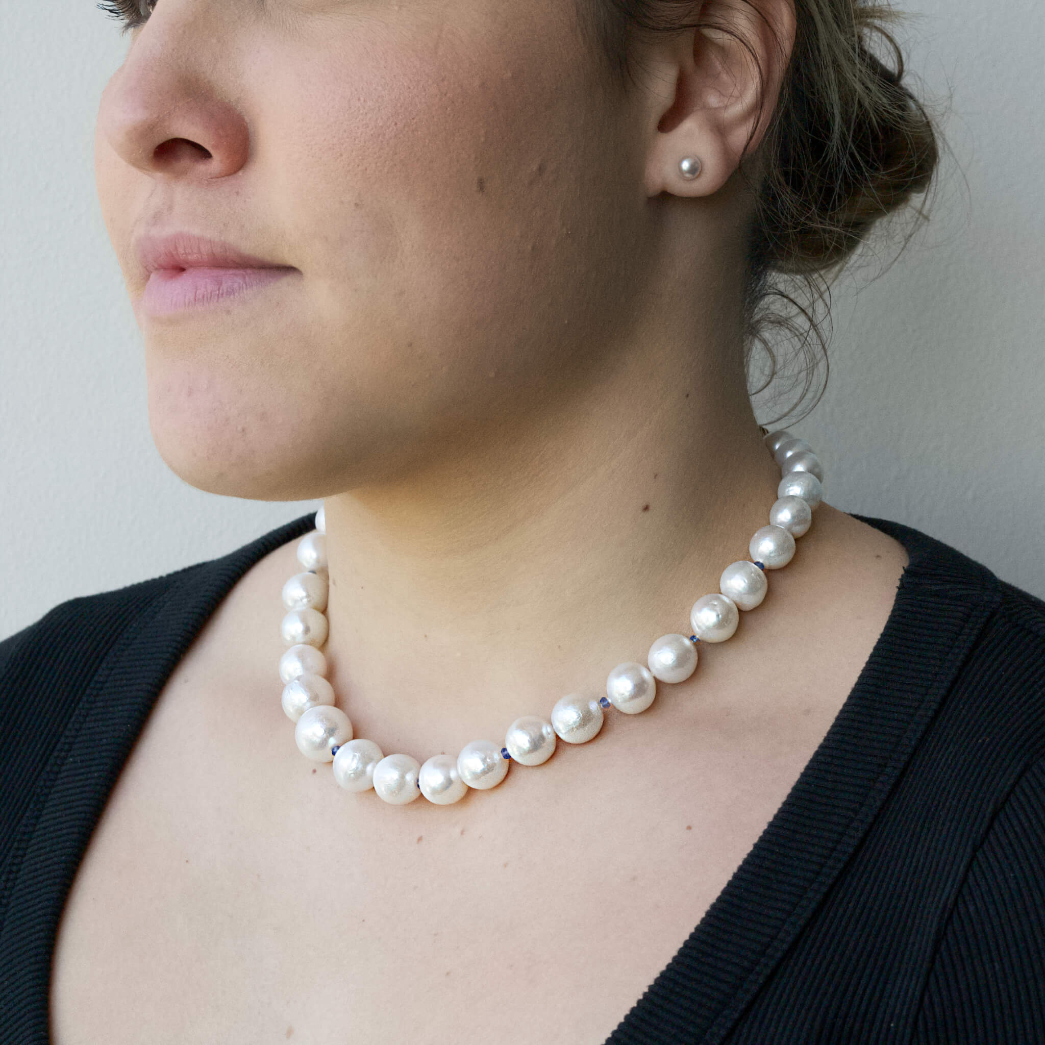 model wearing pastel pearl necklace
