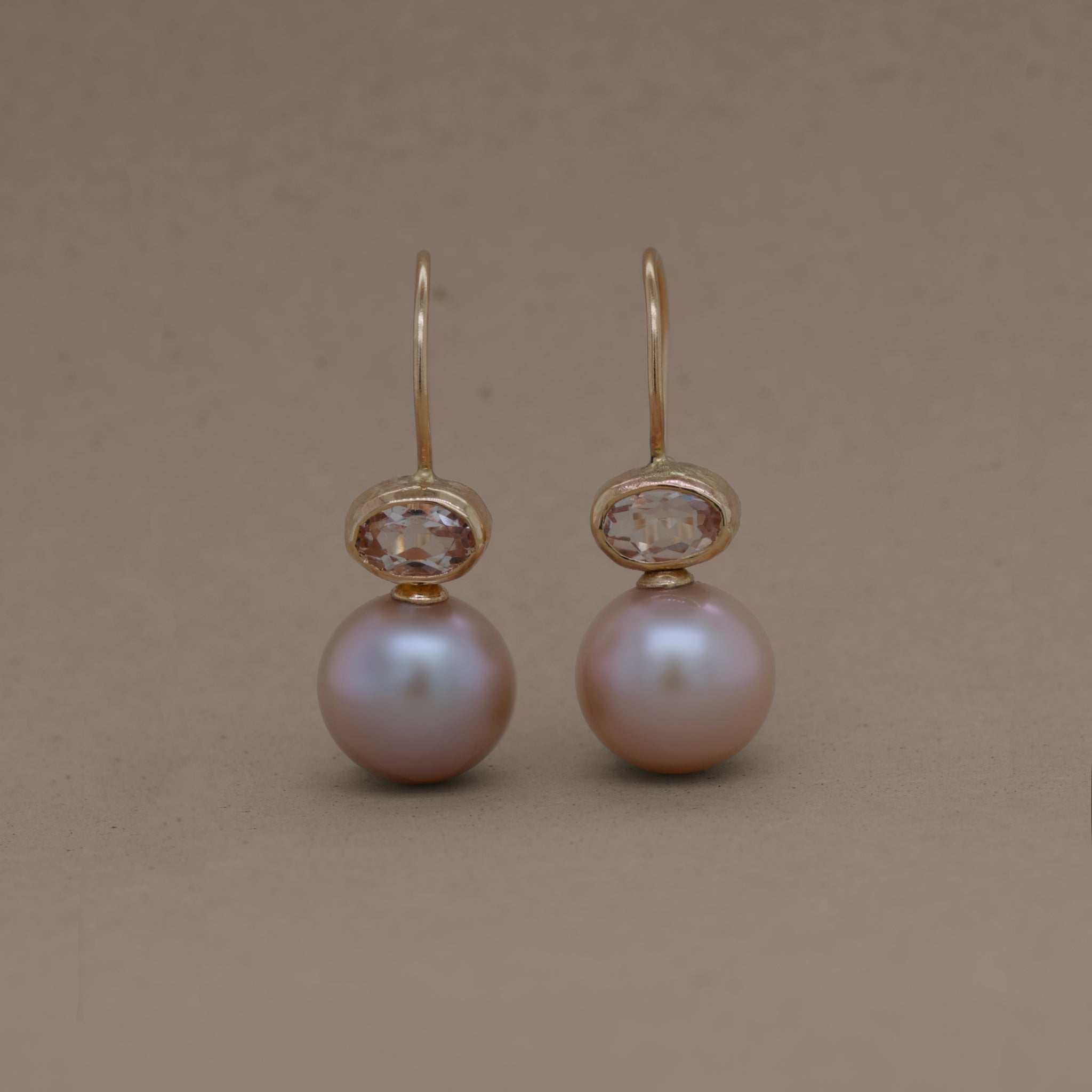 Morganite pink pearl earrings with gold setting.