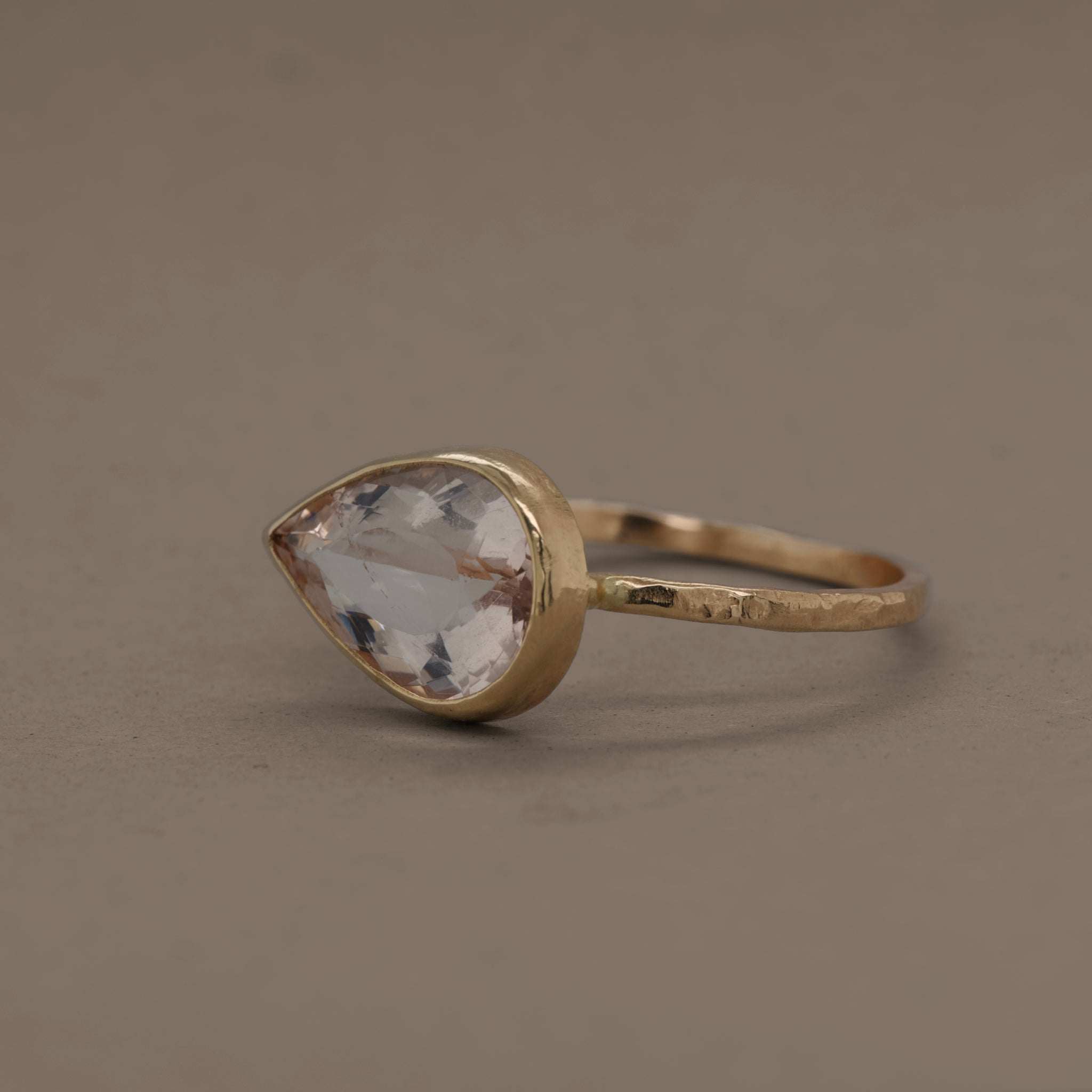 Pear-shaped Morganite ring in 14ct hammered gold setting.