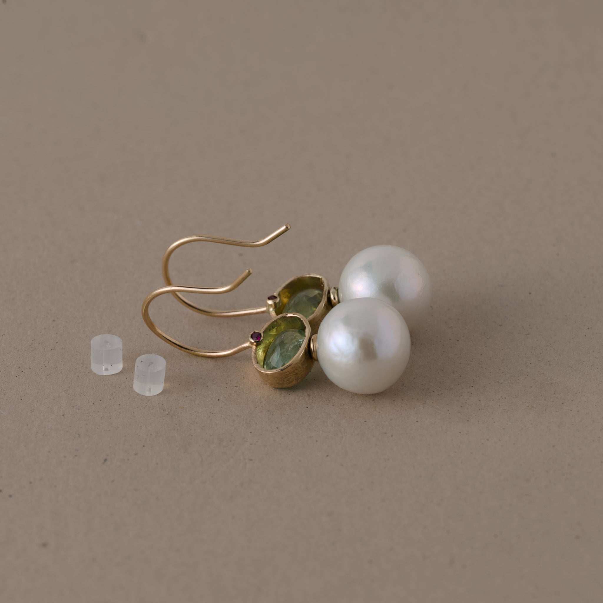 14ct gold pearl earrings with green Paraíba tourmaline and round freshwater pearls on beige background