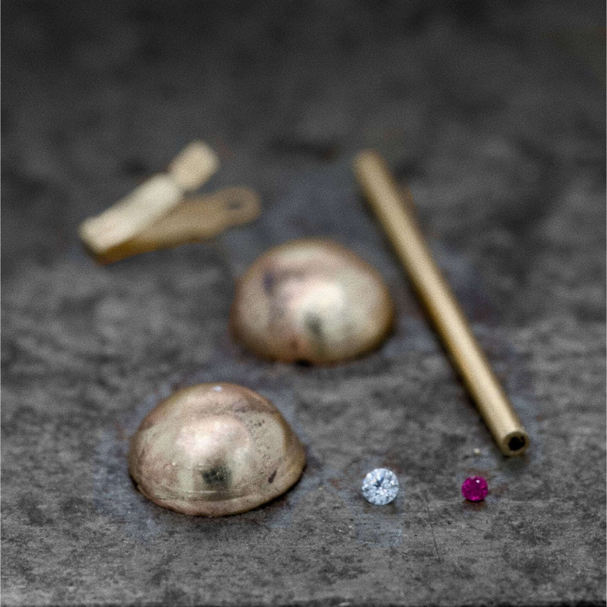 Ondina Freshwater Pearl Necklace with diamond, ruby, and gold clasp components on a textured surface