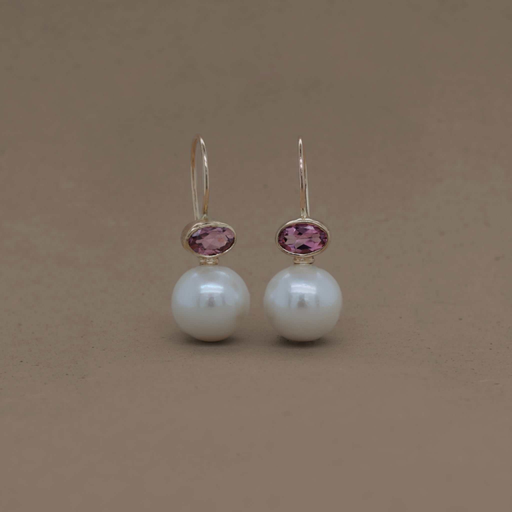Pink tourmaline pearl earrings with gold accents.