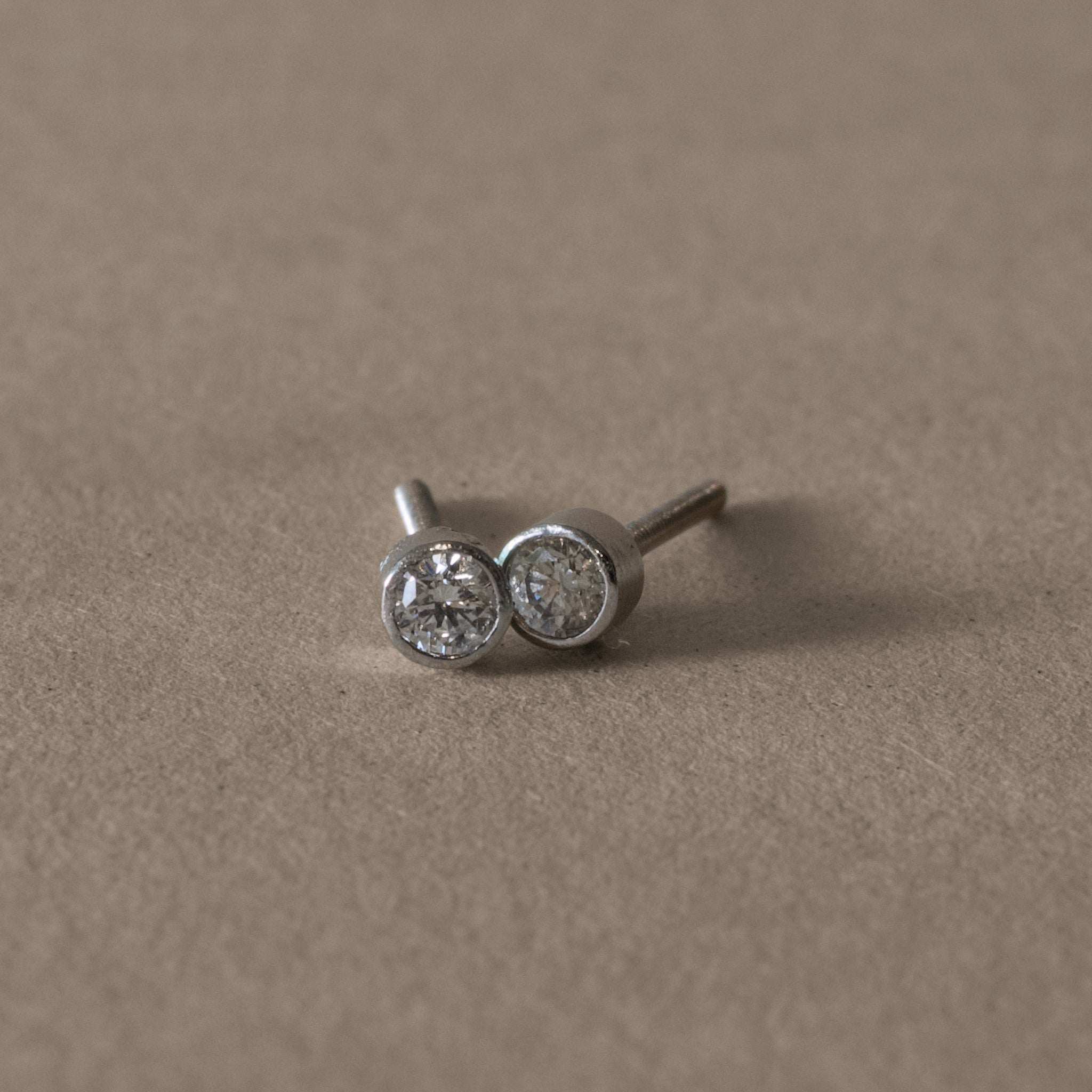Platinum diamond stud earrings with simple, elegant design and sparkle.