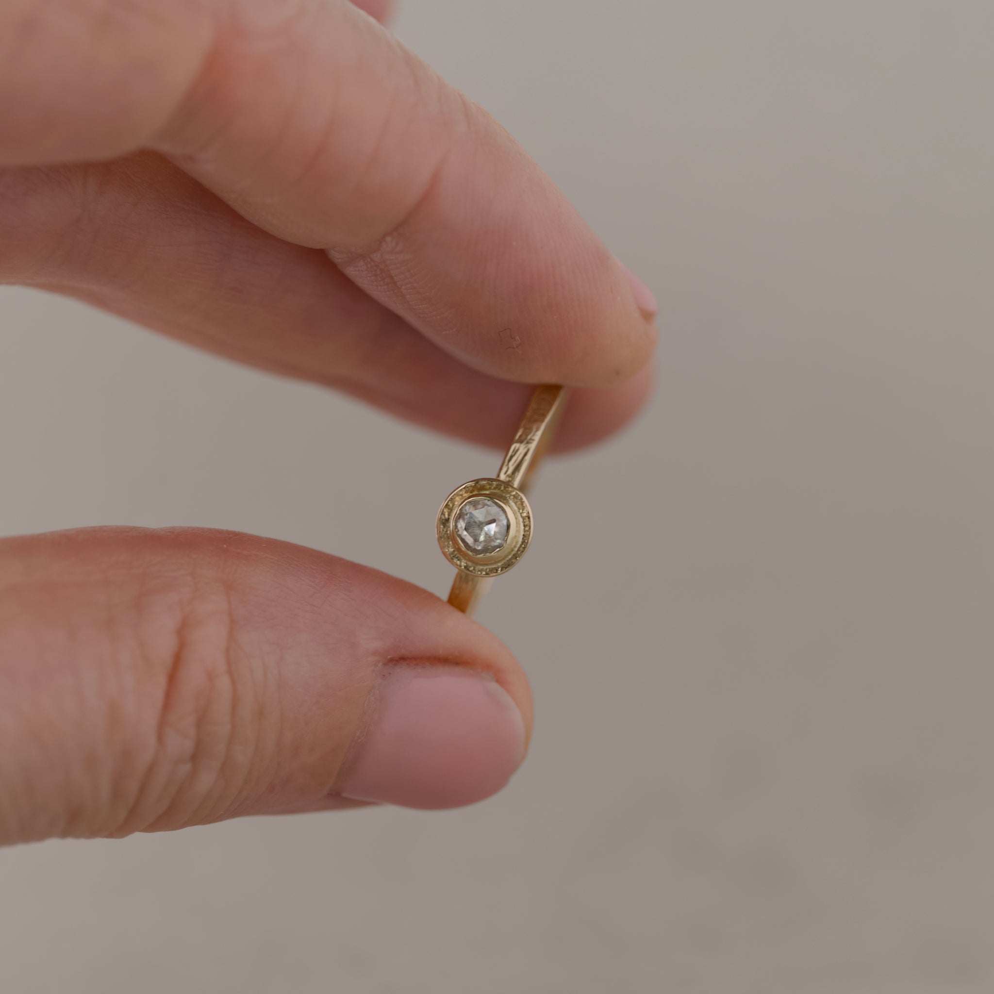 Soletta rose cut diamond ring in textured gold with soft radiant glow