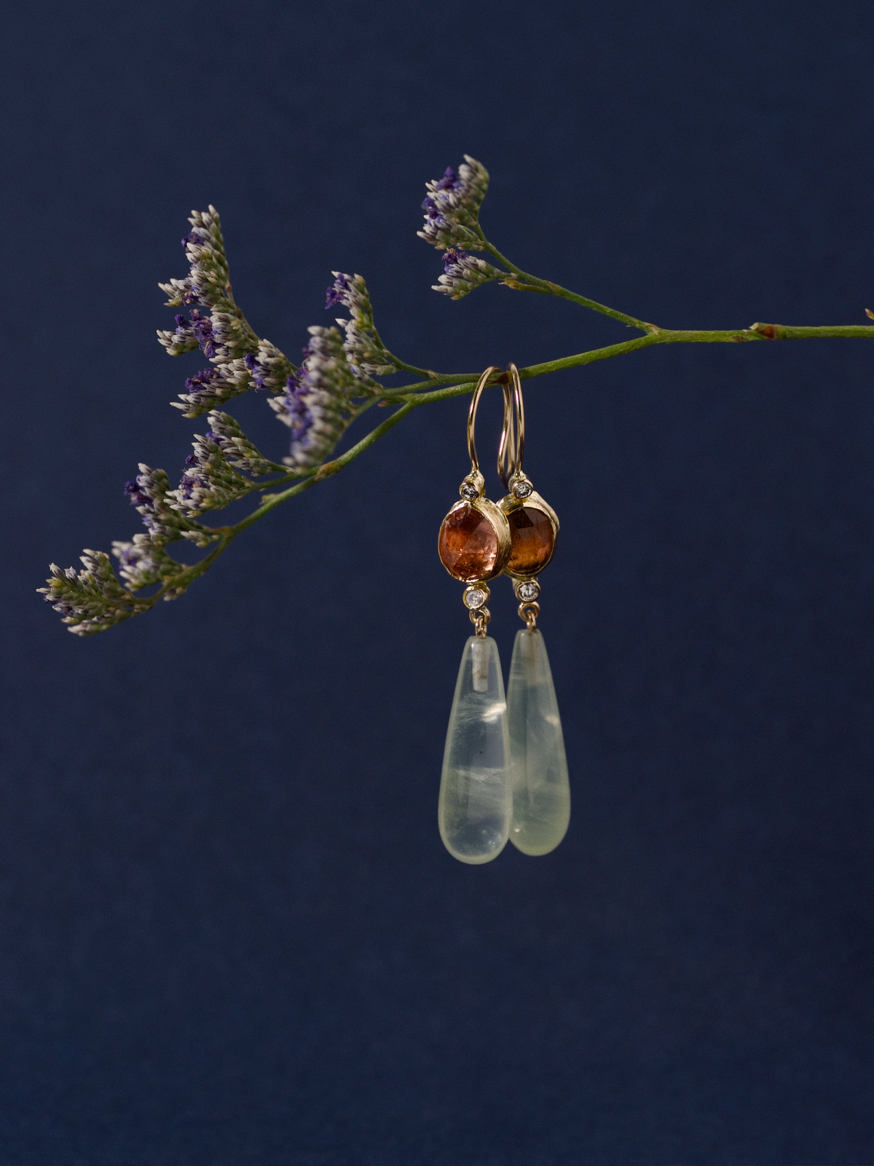 Imperial topaz, diamond and aquamarine drop earrings in 14ct gold on deep blue background