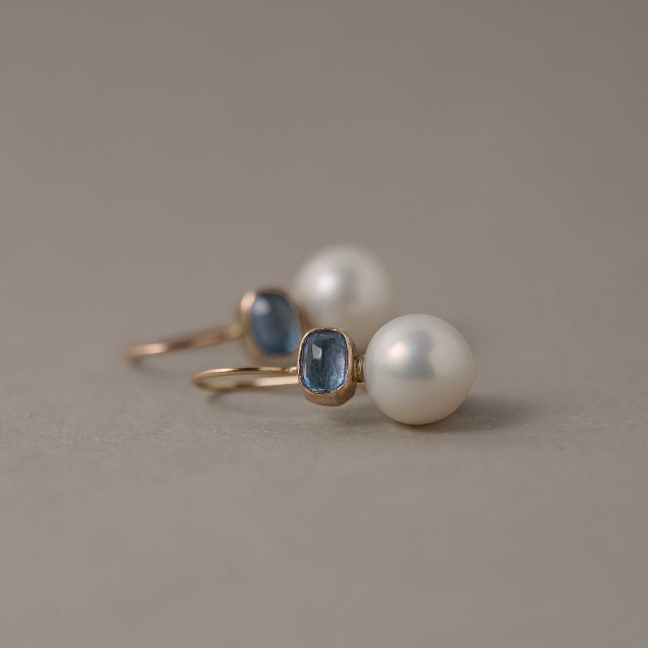 Aquamarine pearl earrings with icy blue stones and gold setting