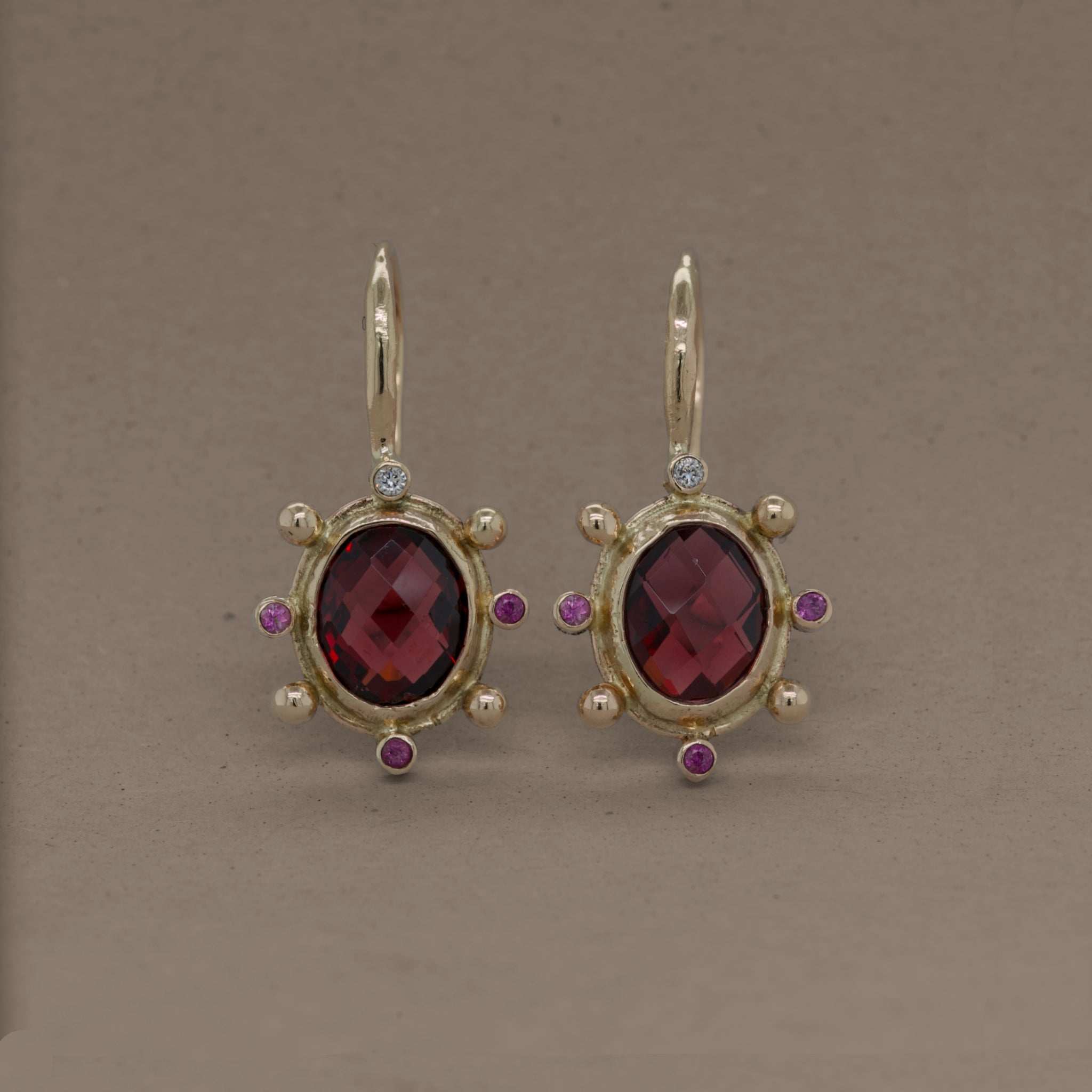 Stella Rhodolite Garnet Earrings with pink sapphires, diamonds, and gold setting.