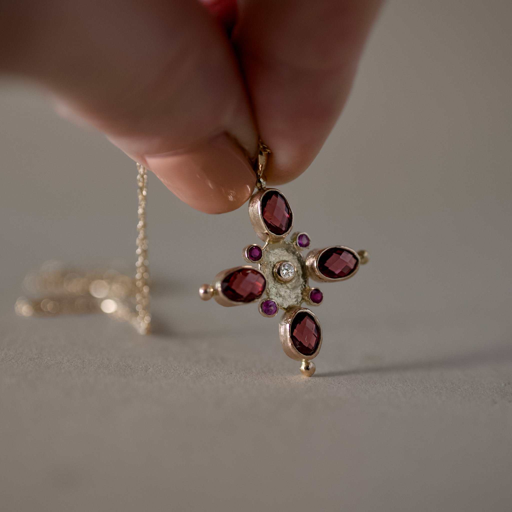 Elegant gold sapphire necklace with garnet, ruby, and diamond accents