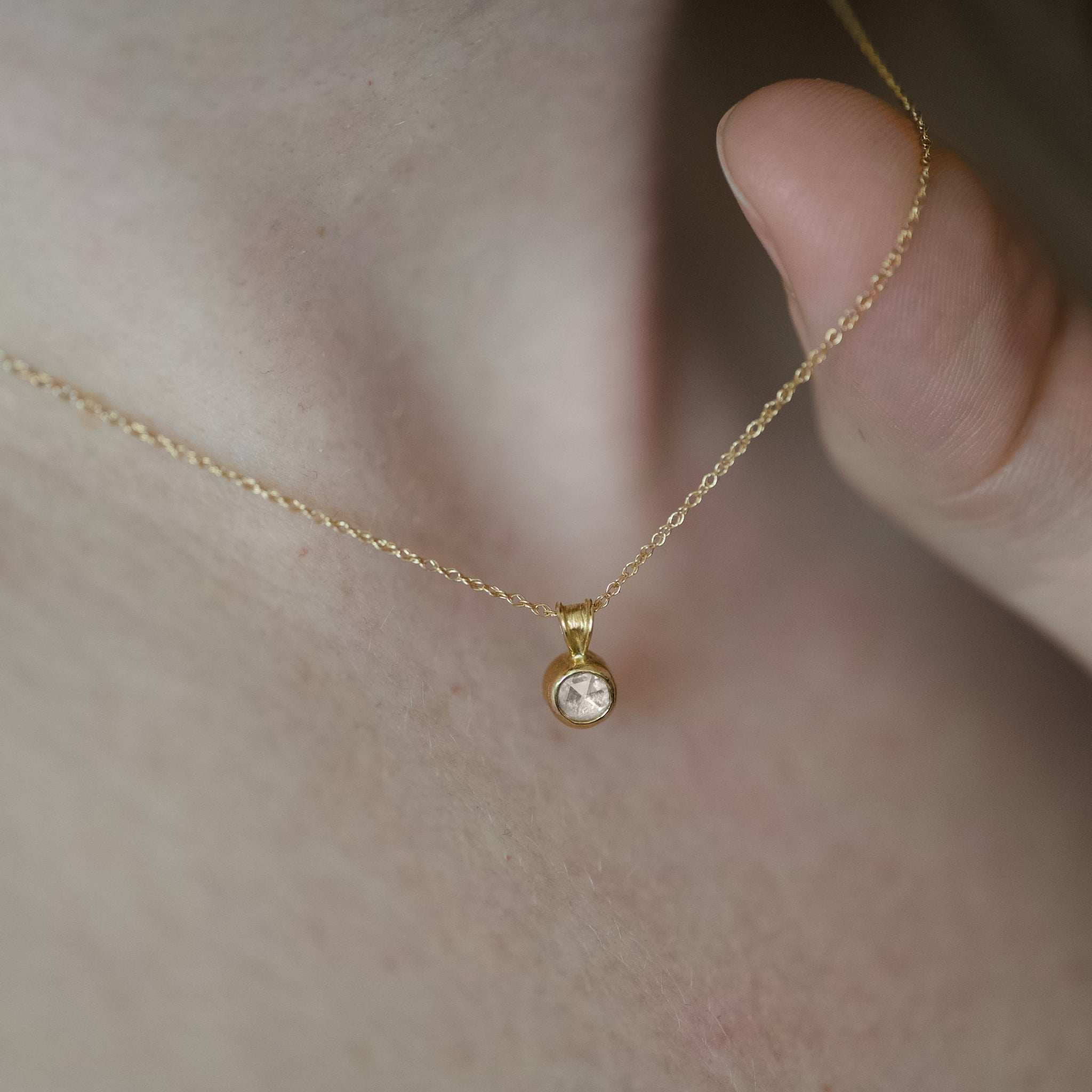 Rose cut diamond pendant necklace in gold with soft glowing facets and elegant design