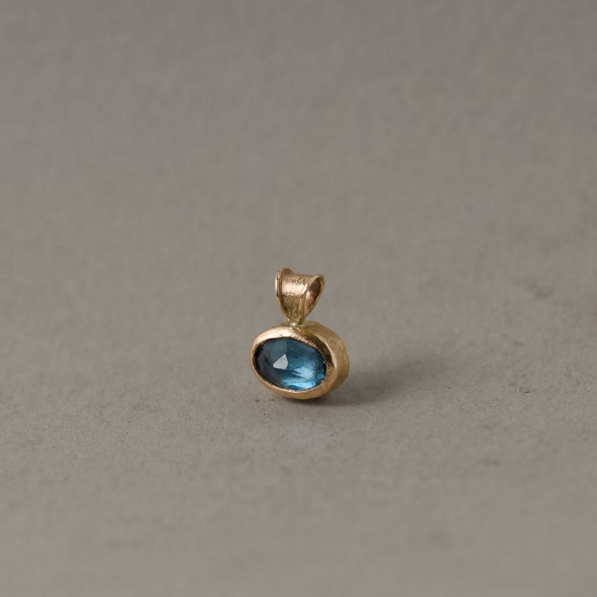 London Blue Topaz pendant in gold setting with teal blue gemstone