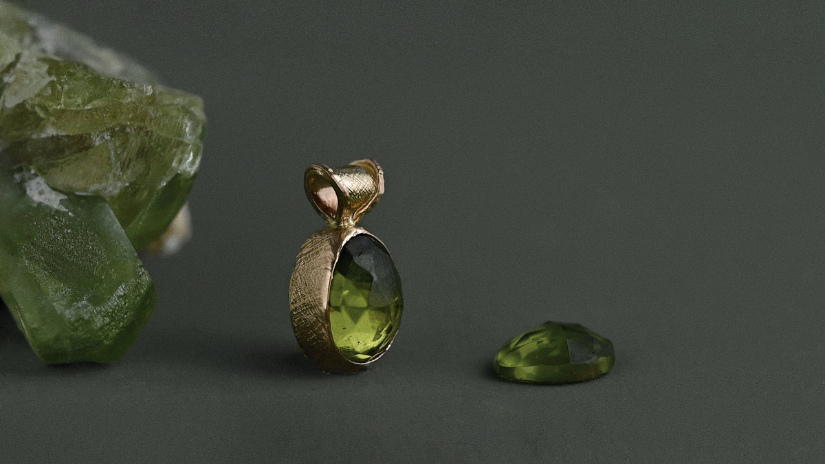 peridot pendant in solid 14ct gold with loose peridot gemstone and peridot crystal 