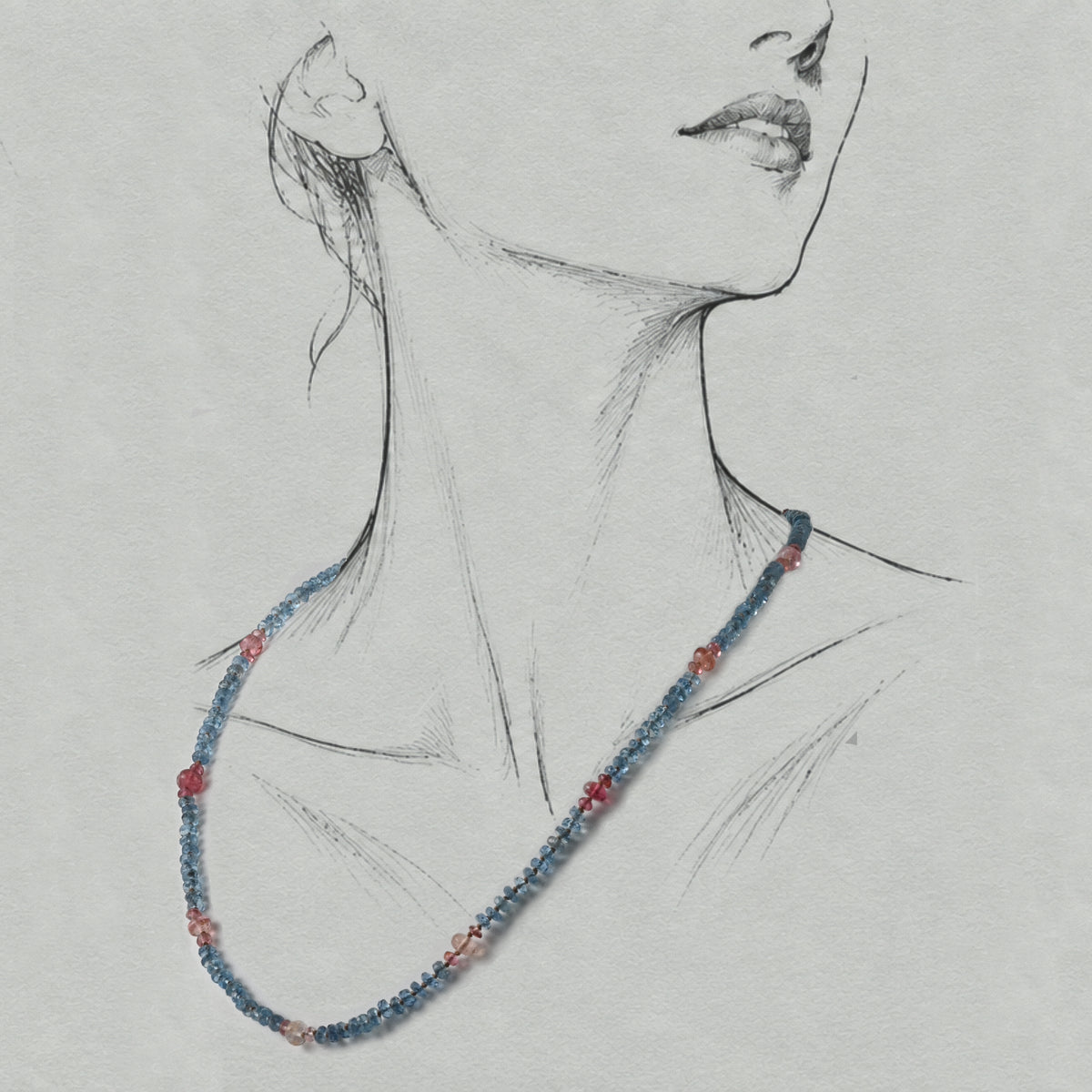 Filo Santa Maria aquamarine and tourmaline silk-strung necklace worn on a graphite illustrated figure.