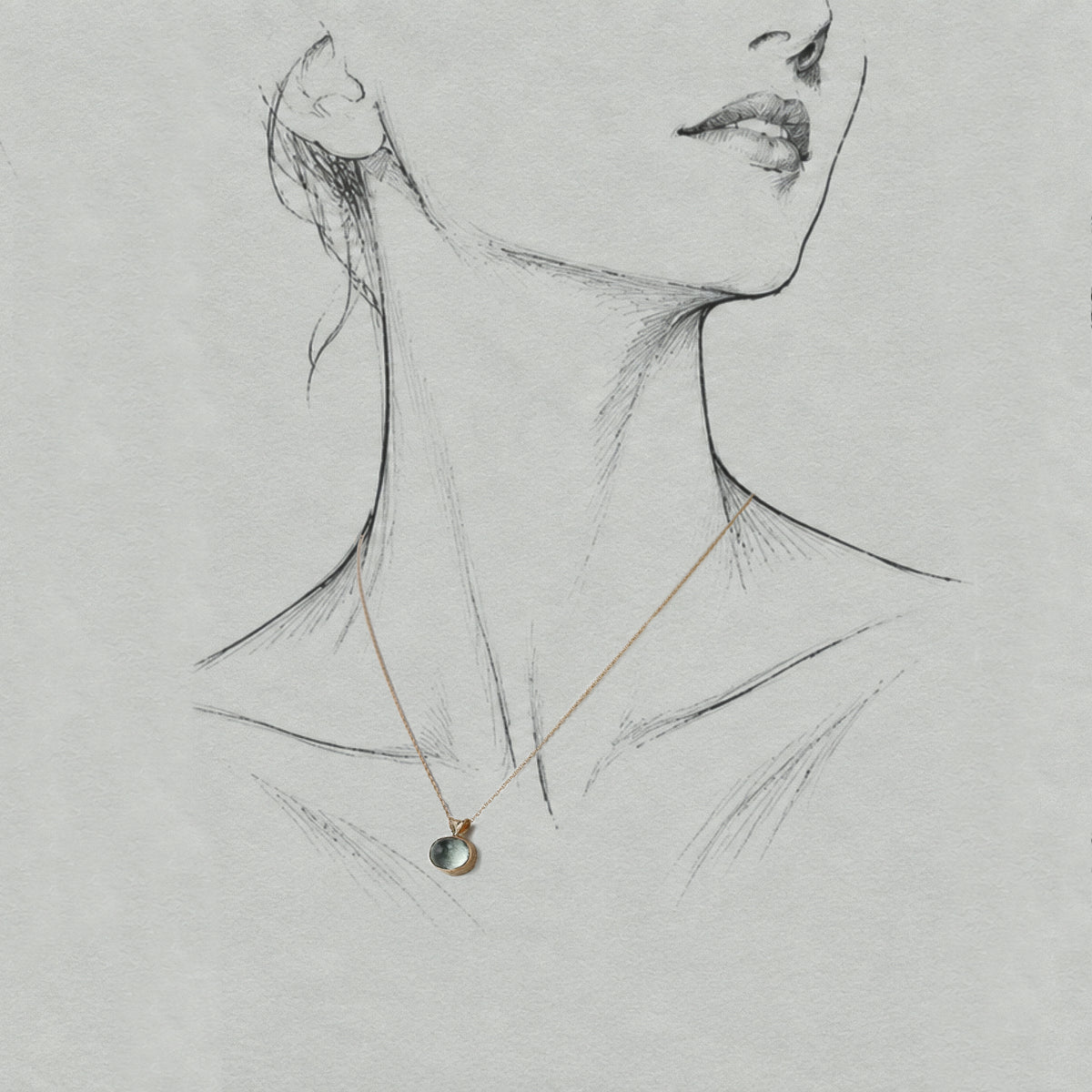 Vermilion Jewellery Uno Paraíba tourmaline pendant in 14ct solid gold, displayed on an artist model with a gold chain.