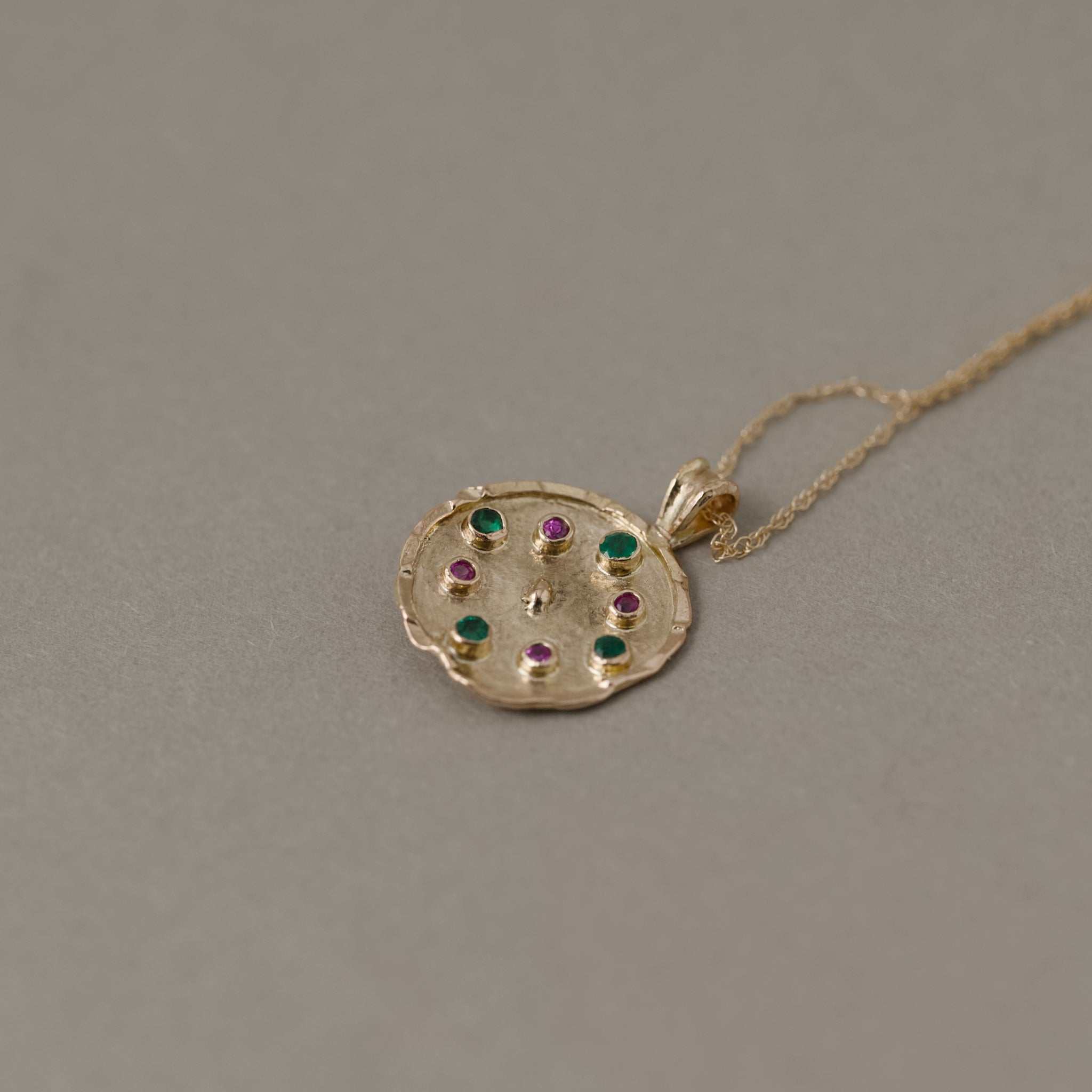 Florin pendant with emeralds, sapphires, set in 14ct gold with double rope chain