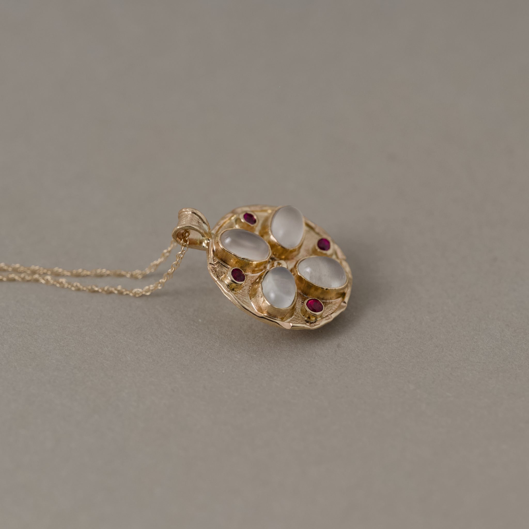Florin 14ct solid gold medallion set with moonstone and ruby gemstones and solid gold chain