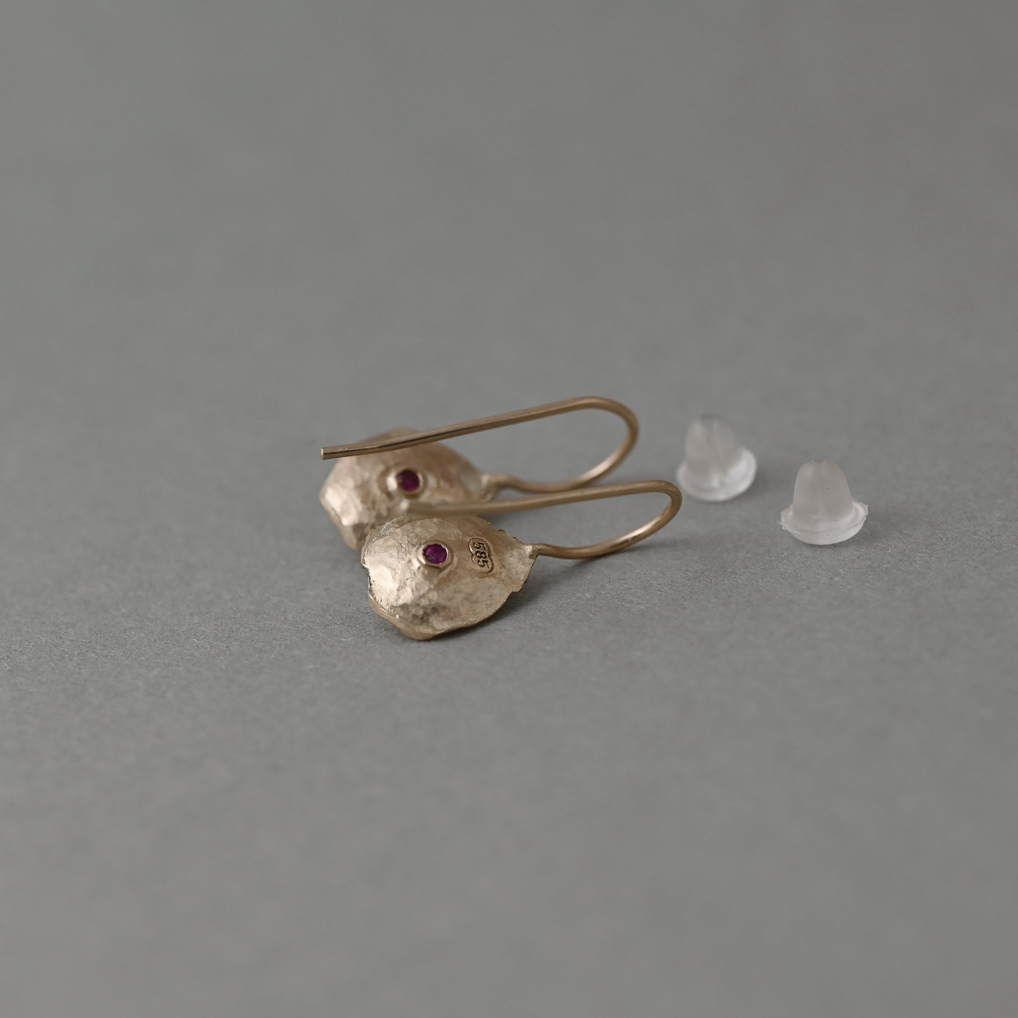 Back of Florin ceylon blue sapphire earrings in 14ct gold showing hallmark and ruby gemstone detail 