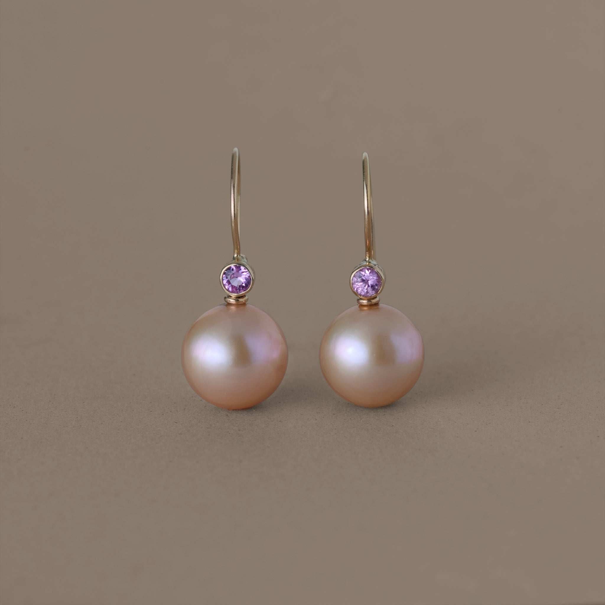 Golden rose freshwater pearl earrings with pink sapphire accents on gold hooks