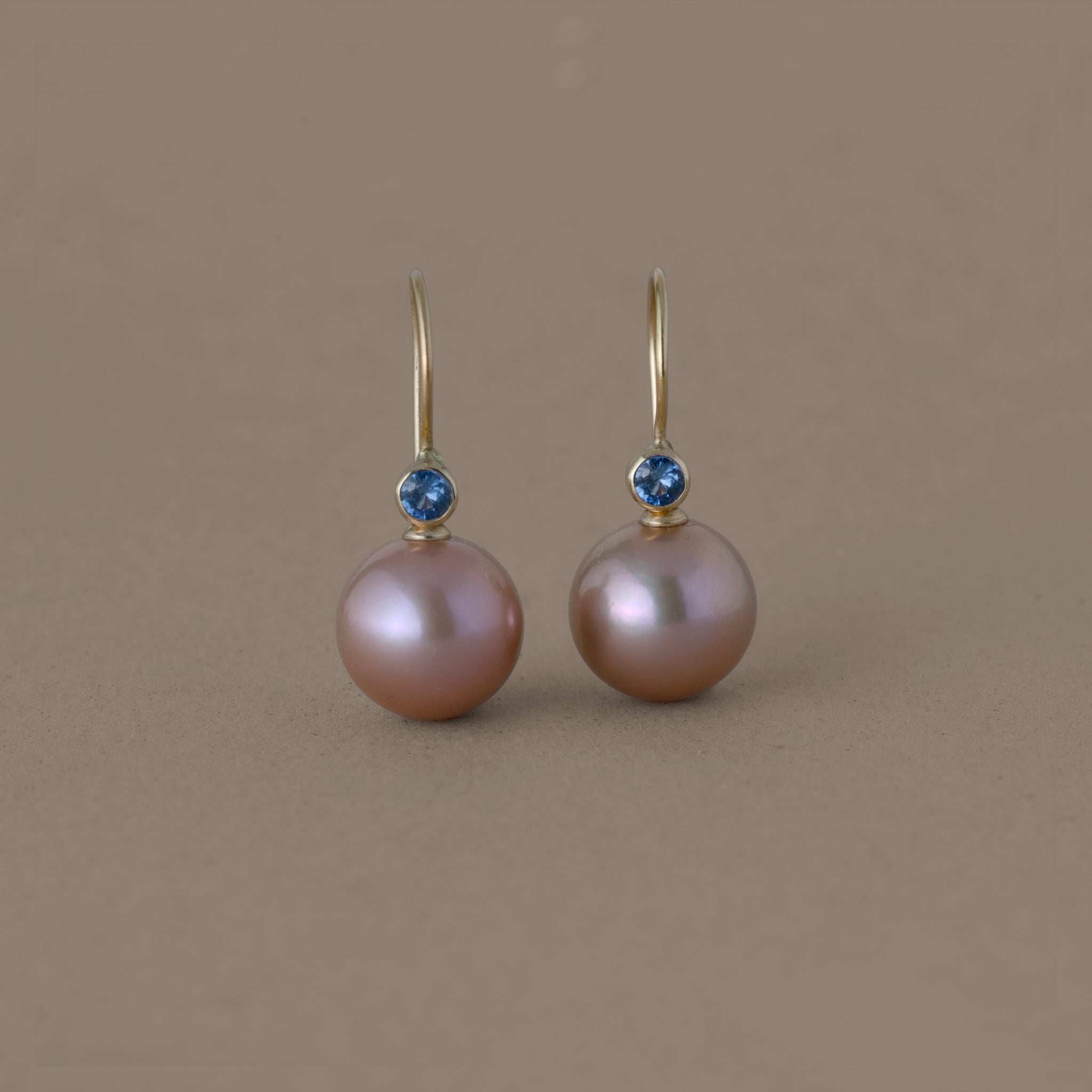Latte rose freshwater pearl earrings with blue sapphire and gold setting