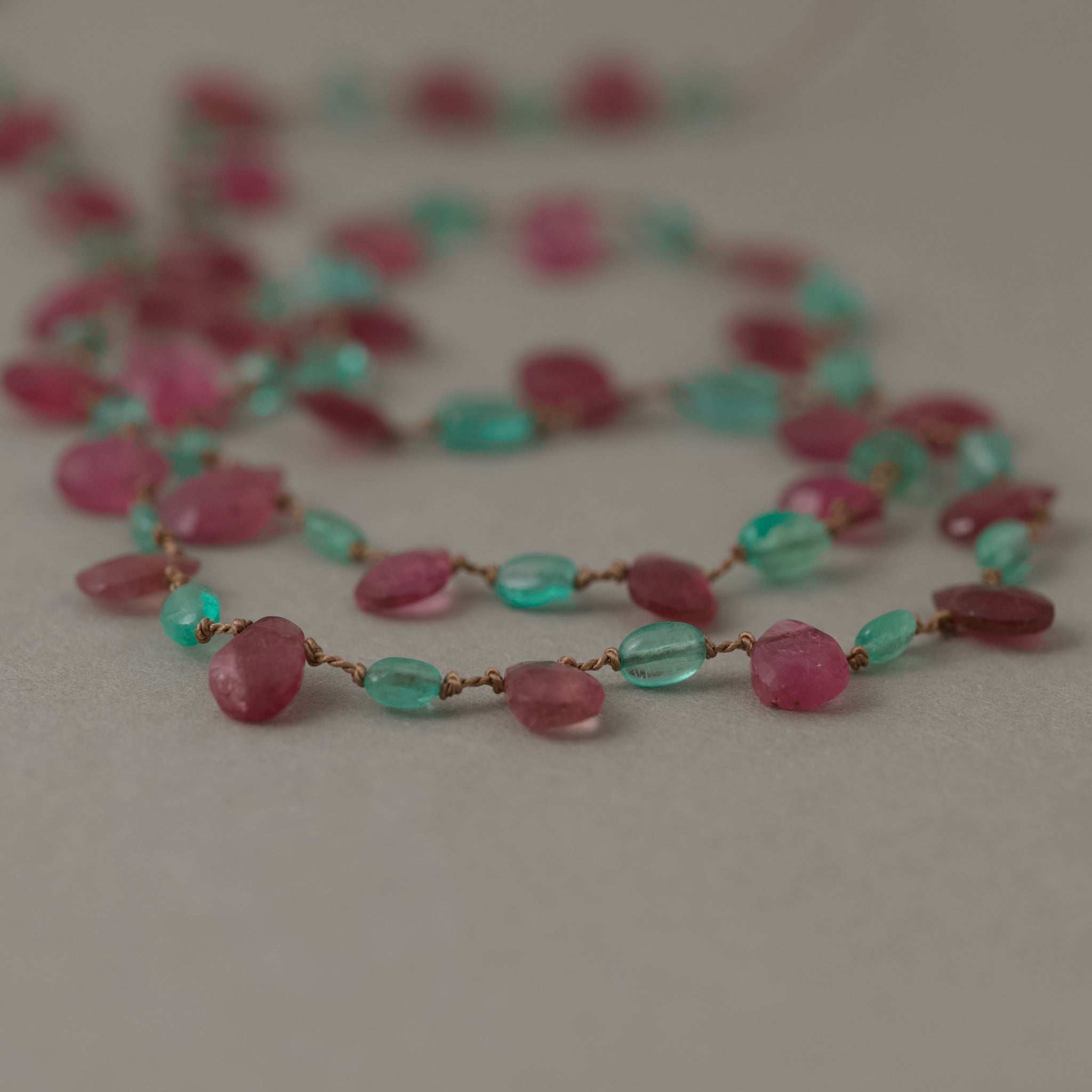Lido Colombian Emerald diamond necklace with gold clasp and ruby detail on silk strand