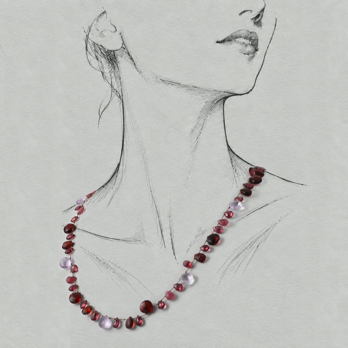 Lido garnet and tourmaline silk-strung necklace worn on a graphite illustrated figure.