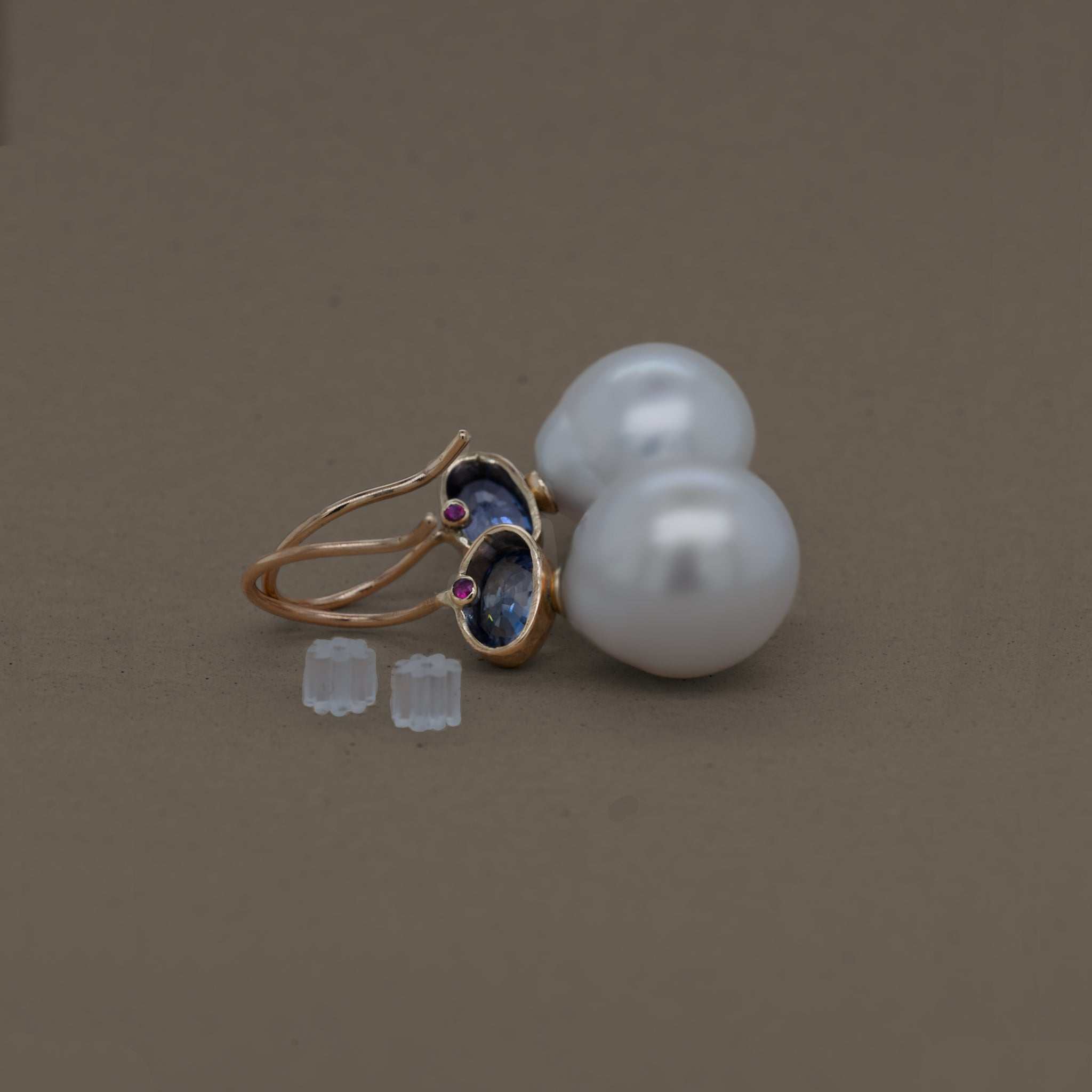 Elegant blue sapphire pearl earrings adorned with Ceylon sapphire and gold, symbolizing grace and serenity.