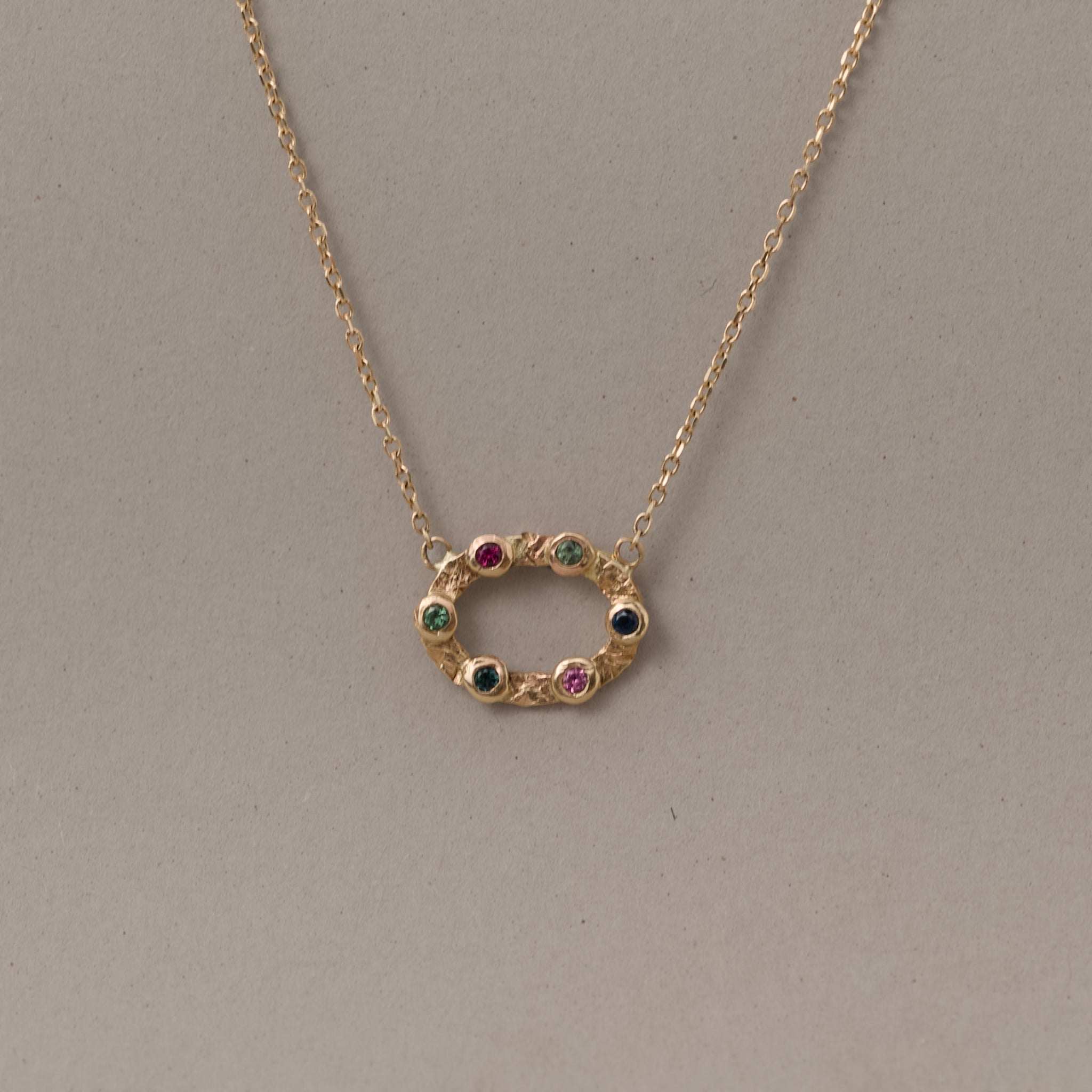 14ct gold open circle of mixed tourmaline gemstones pendant