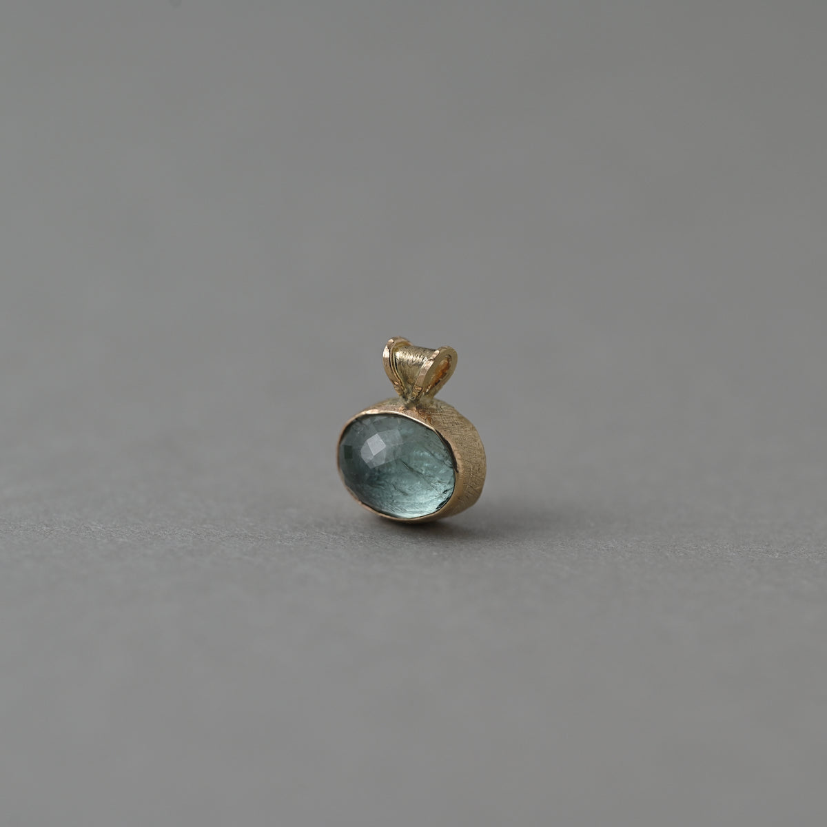 Vermilion Jewellery Uno Paraíba tourmaline pendant in 14ct solid gold, showing the gemstone .