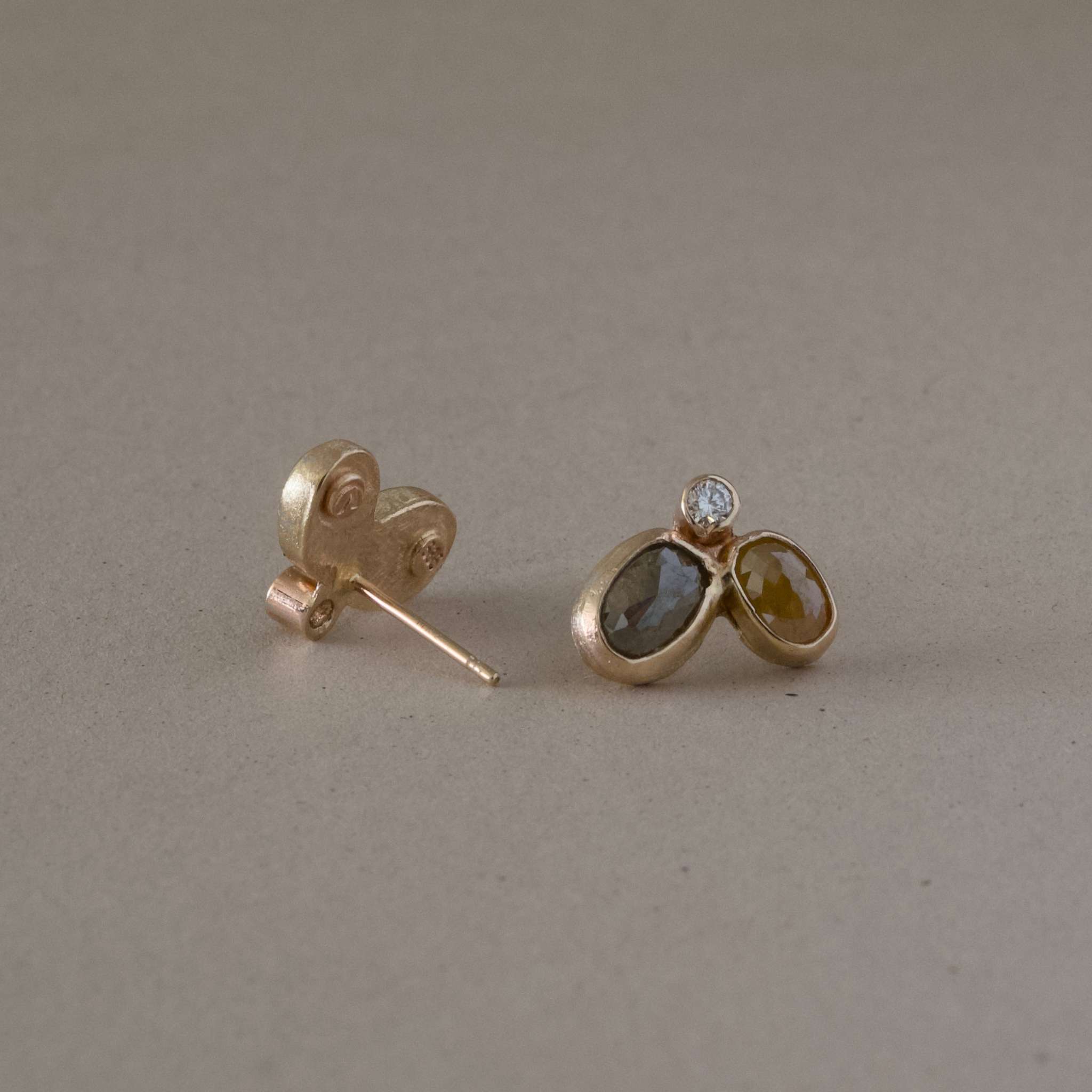 natural diamond earrings with gold setting and raw facetted diamonds.