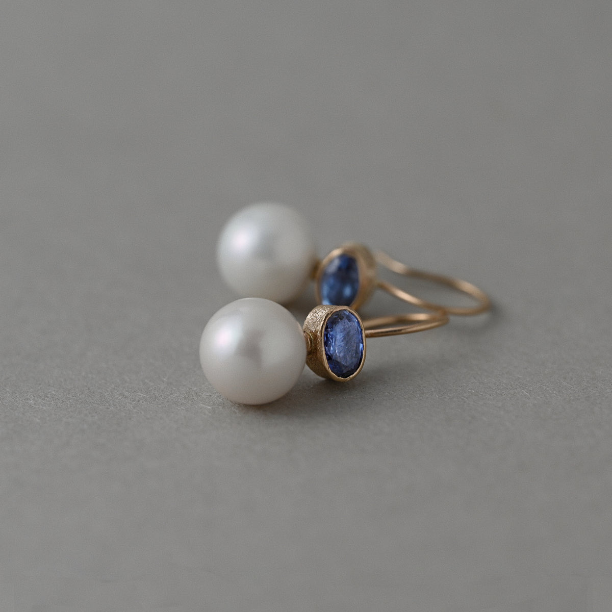 Ceylon blue sapphire and white freshwater pearl earrings in solid 14ct gold