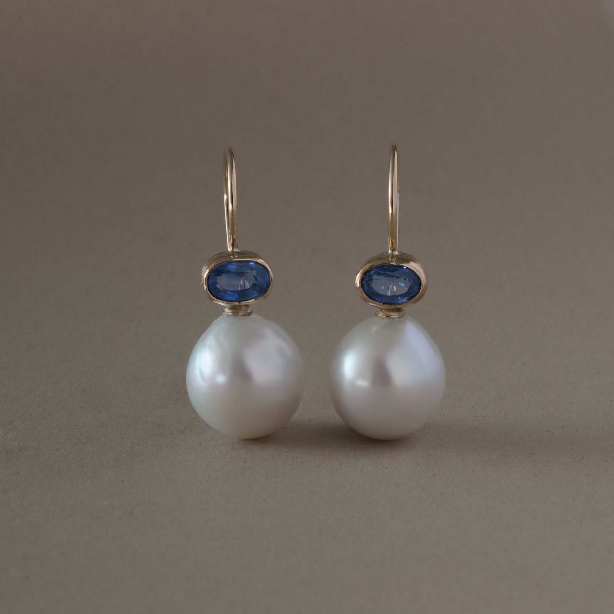 Freshwater pearl and blue sapphire earrings in 14ct gold.