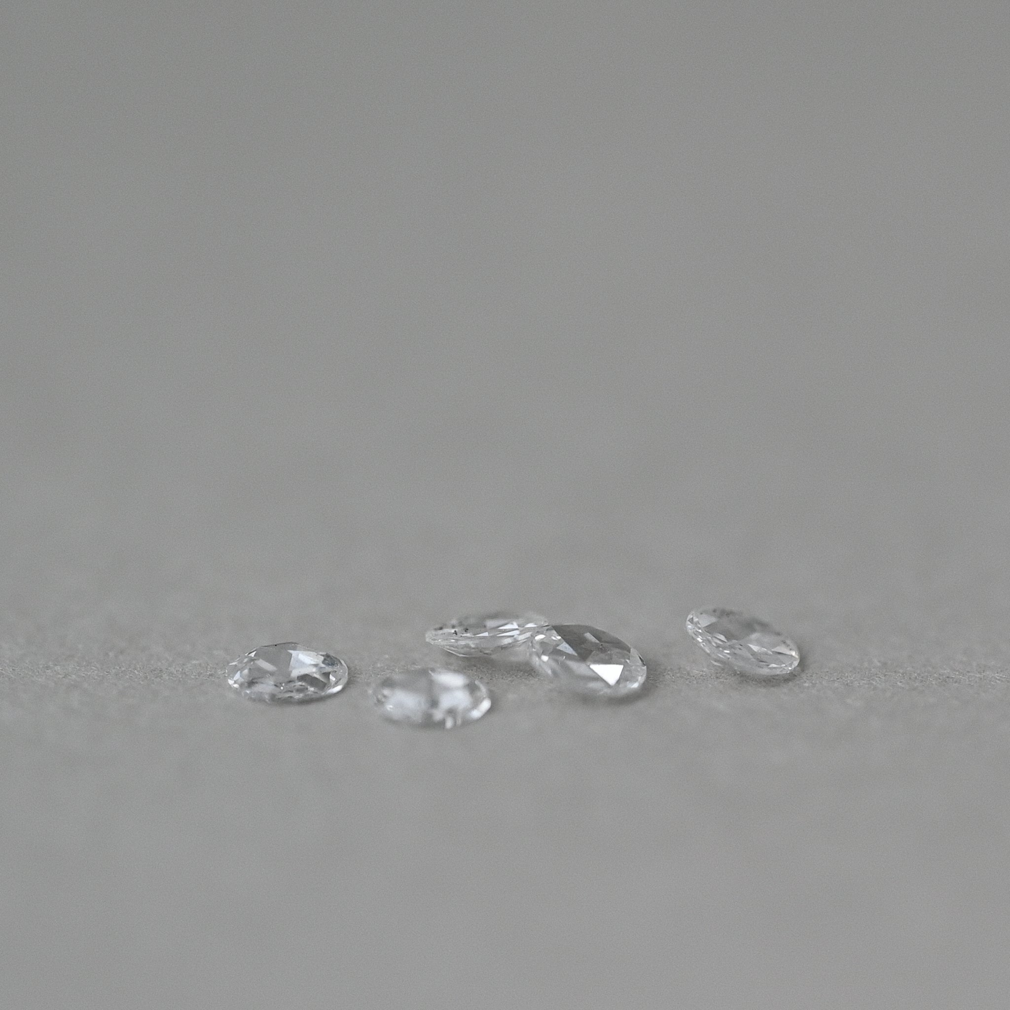 loose rose cut natural diamonds on grey paper