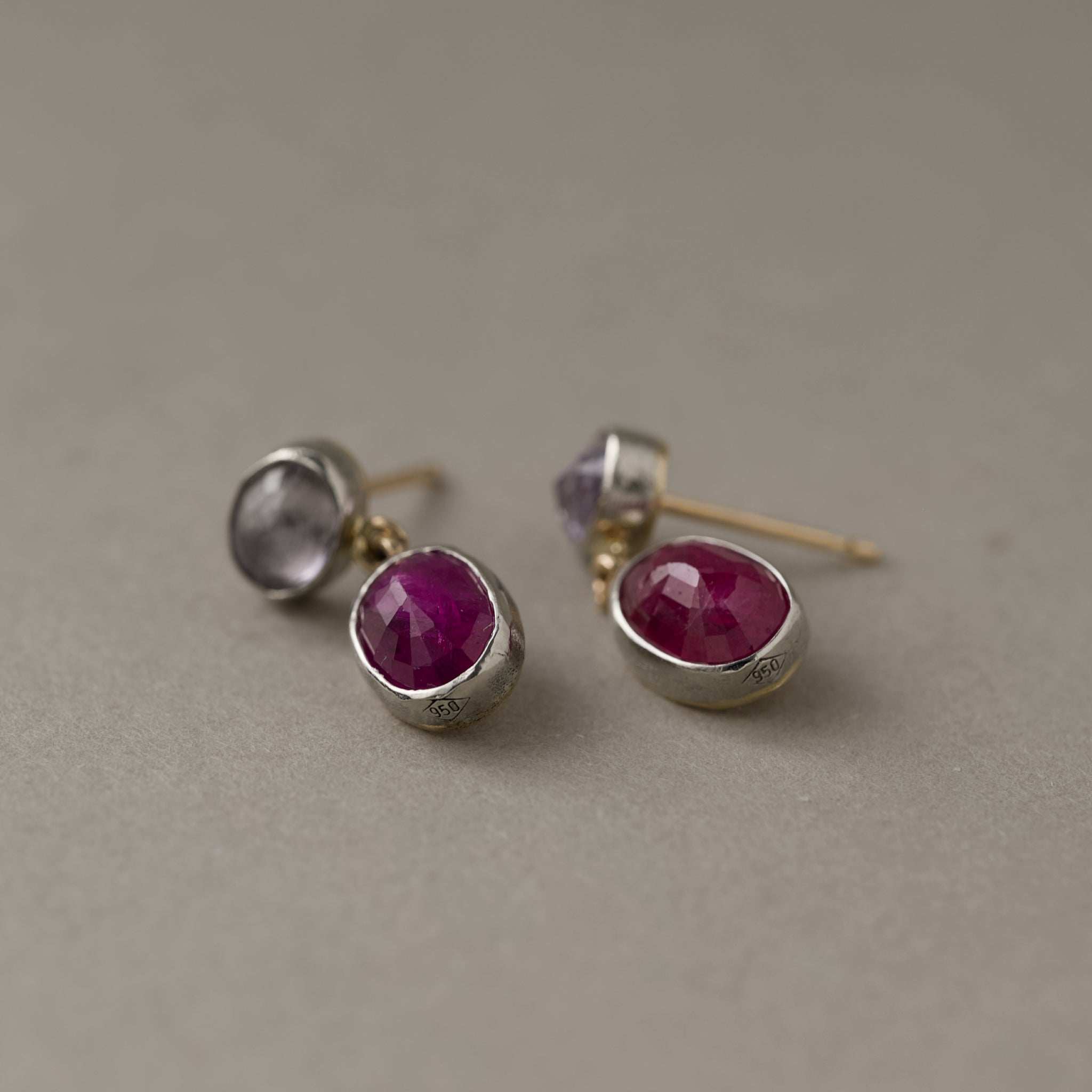 Duo ruby spinel platinum stud earrings showing platinum hall mark  with rubies and pastel spinels in solid gold and platinum, one of a kind