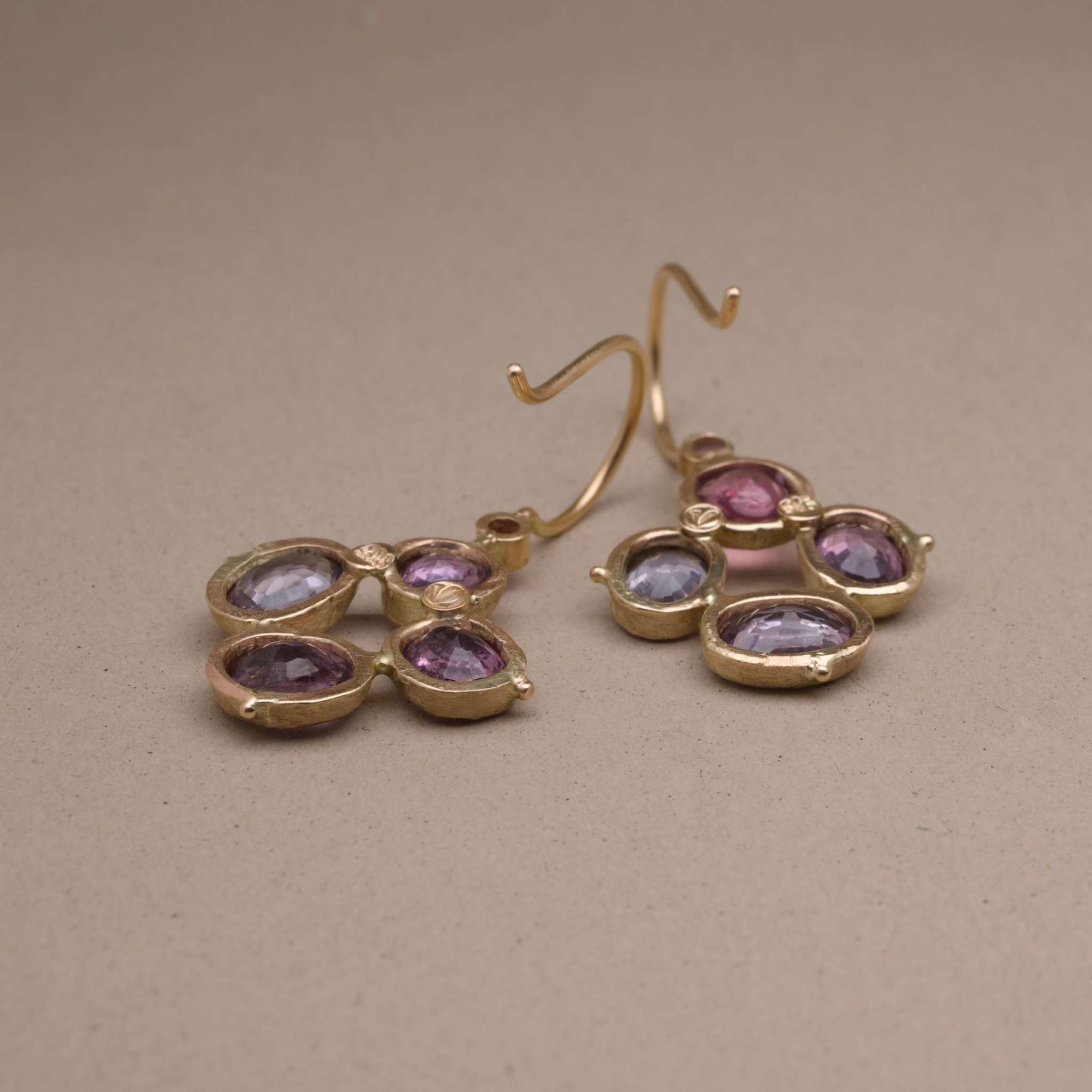 Flora Spinel Sapphire flower Earrings with plum and grey spinel stones in gold setting.