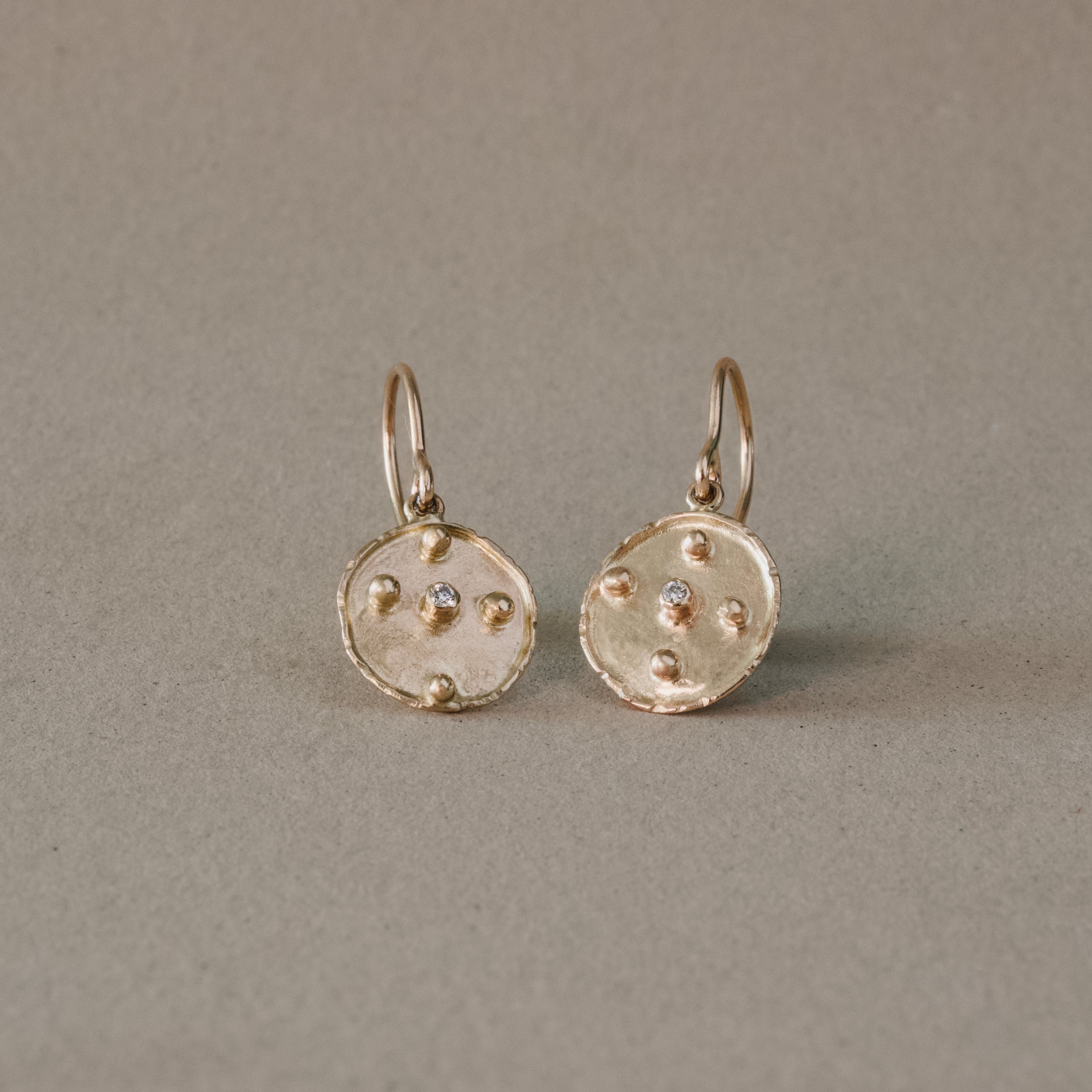 florin oro diamond earrings with 14ct gold medallions and brilliant cut diamonds.