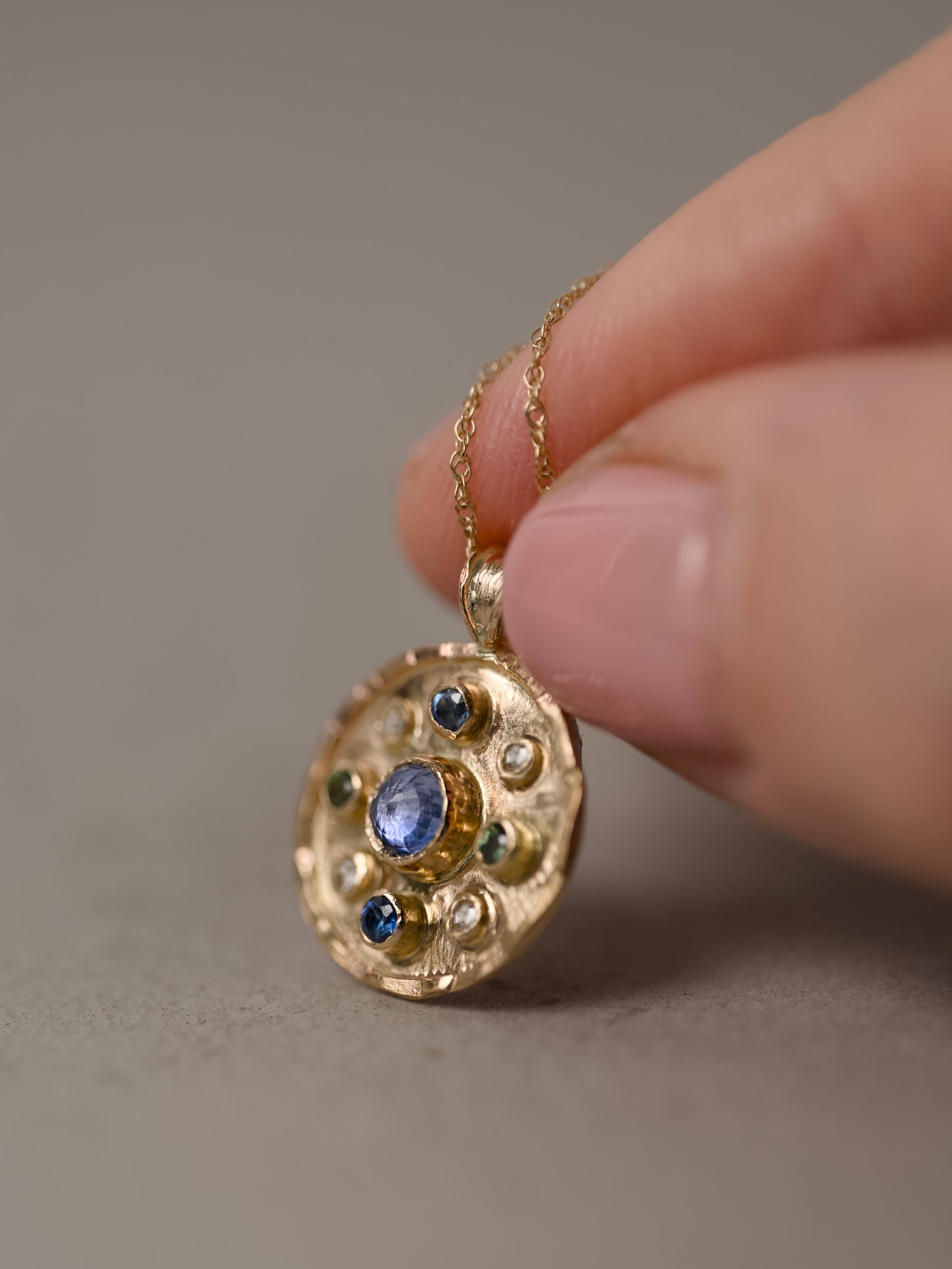 Gold Florin pendant with diamonds shown on hand