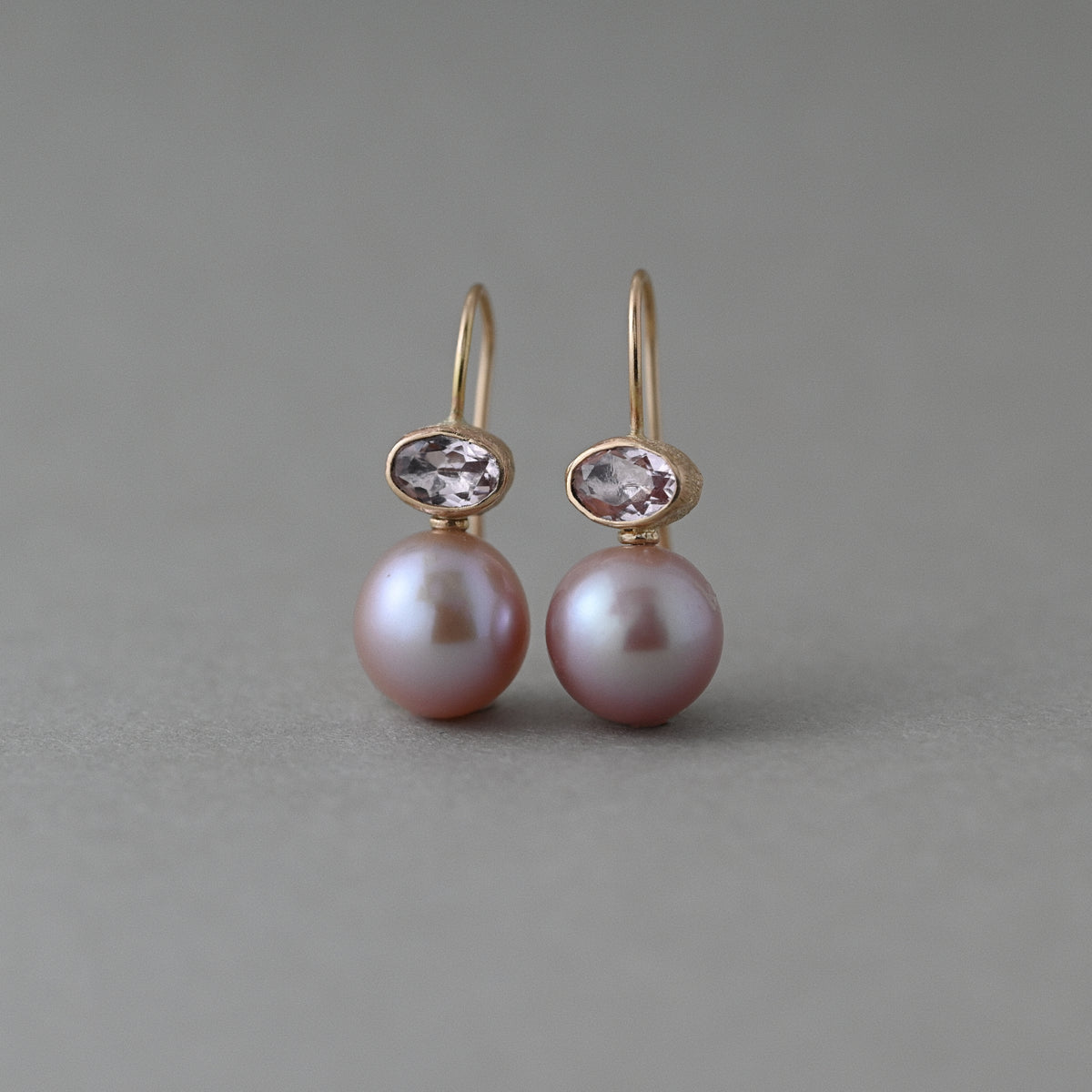 Morganite and pink freshwater pearl earrings in 14ct solid gold, upright front view showing peach morganite gemstones and pink pearls.