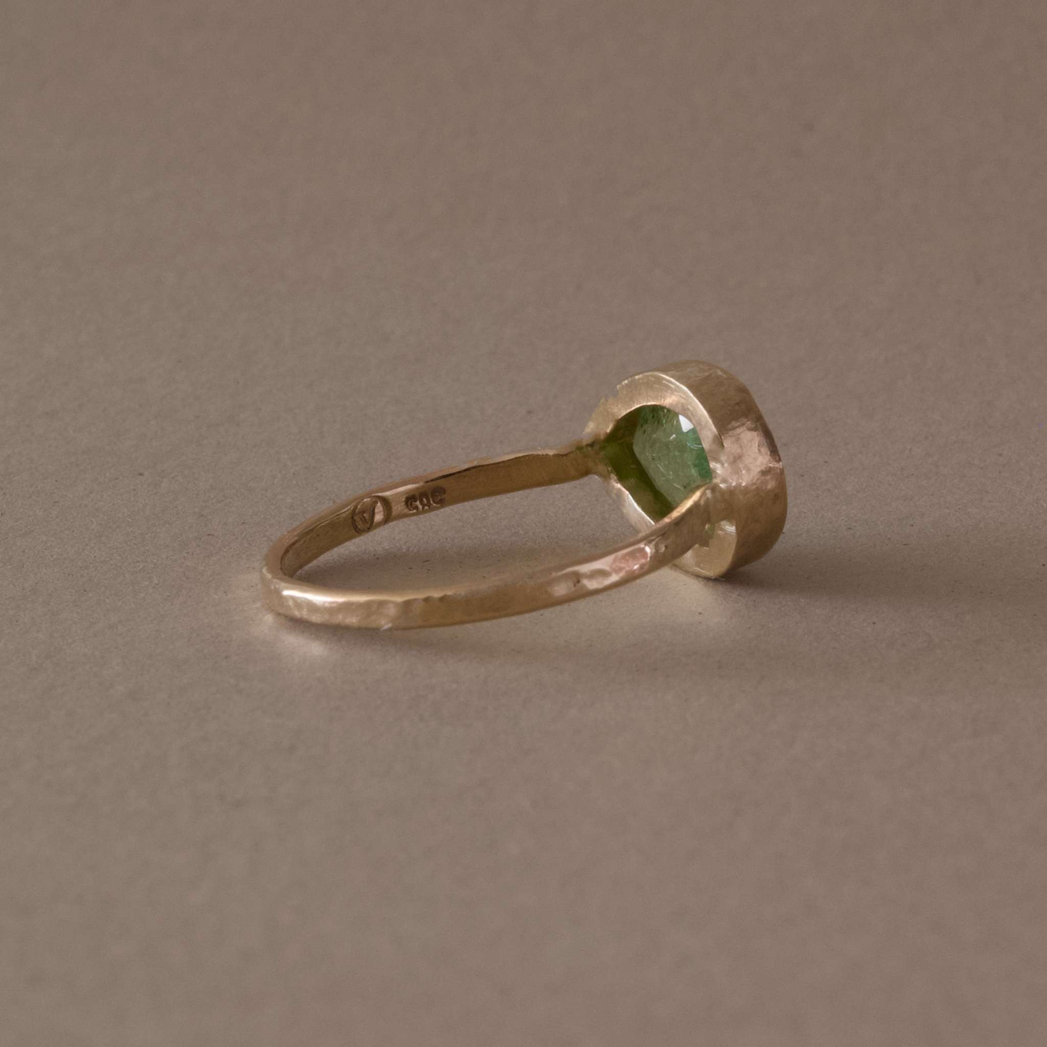 Pero Paraiba Tourmaline Ring set in hammered gold band ring.