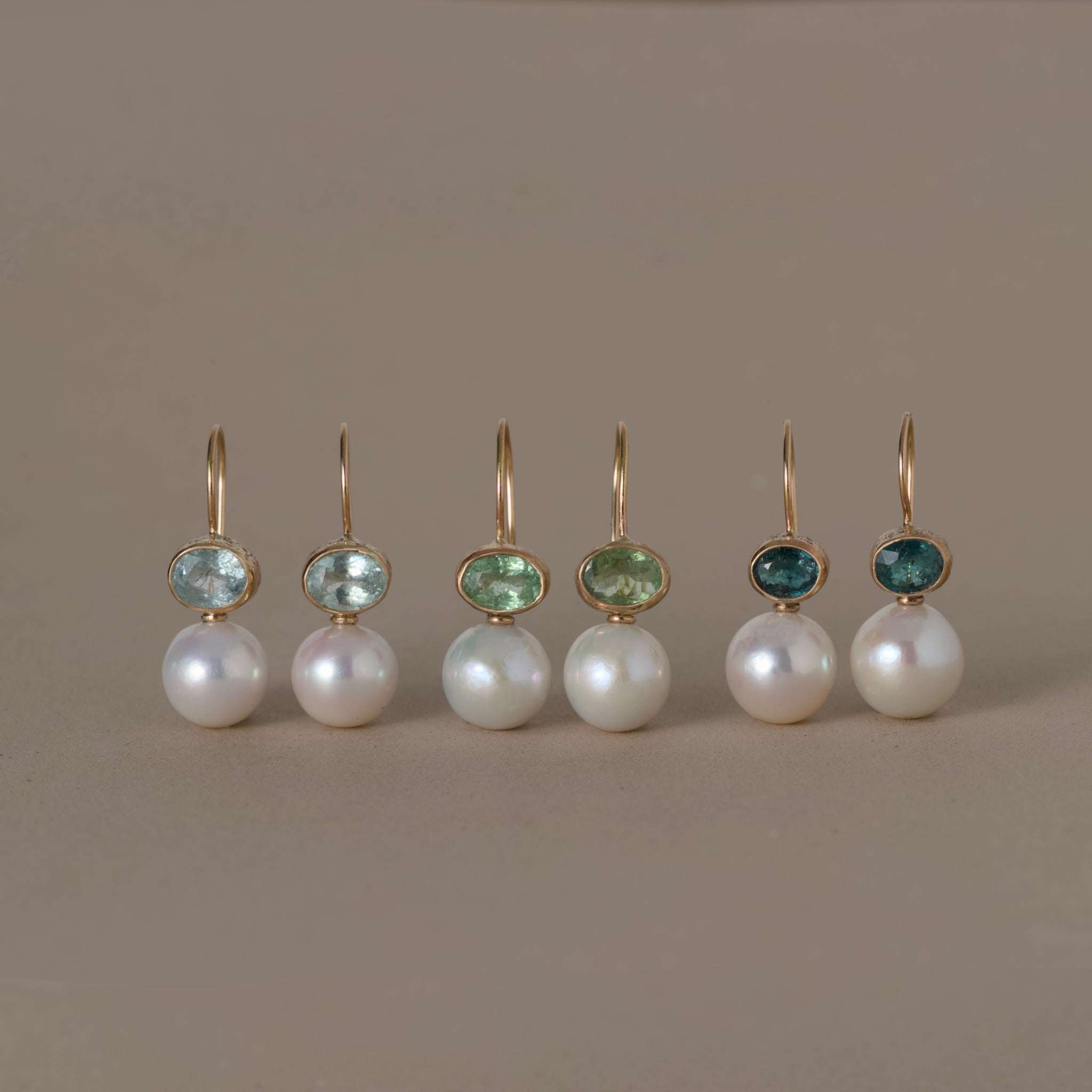 Elegant pearl earrings with green tourmaline stones set in 14ct gold, artisan-made unique design
